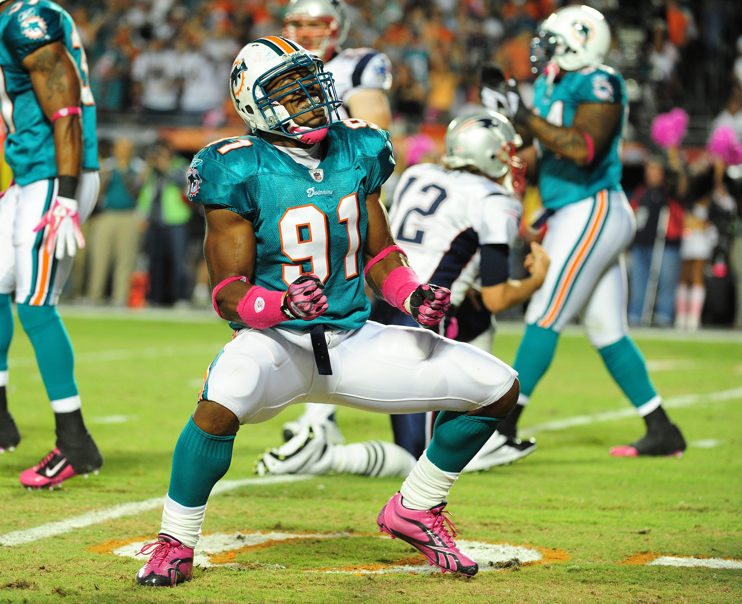 MIAMI - OCTOBER 4: Cameron Wake #91 of the Miami Dolphins celebrates after a play against the New England Patriots at Sun Life Field on October 4, 2010 in Miami, Florida. (Photo by Scott Cunningham/Getty Images)