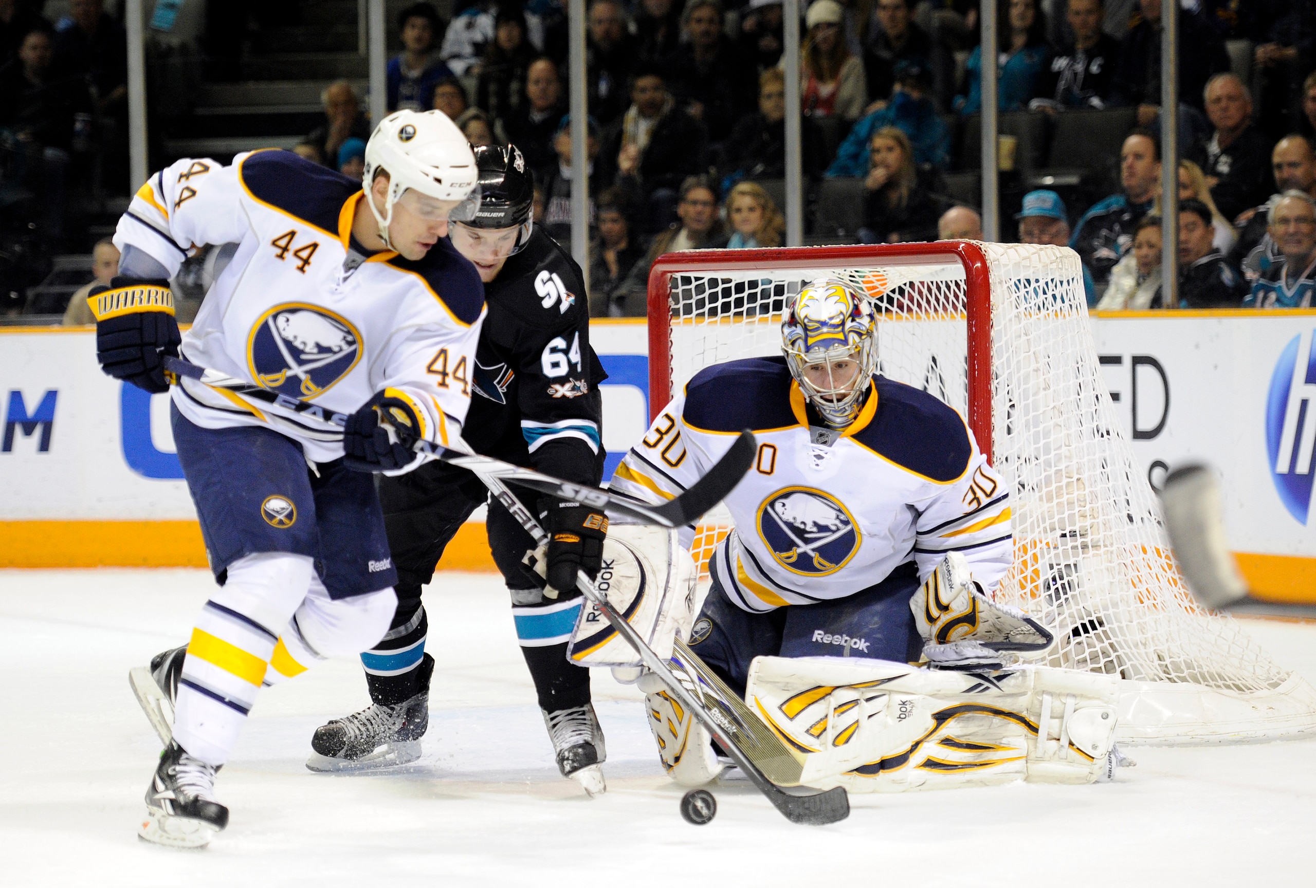 SAN JOSE, CA - JANUARY 6: Jamie McGinn #64 of the San Jose Sharks battles for the puck with Andrej Sekera #44 of the Buffalo Sabres in front of goalie Ryan Miller #30 during an NHL hockey game at the HP Pavilion on January 6, 2011 in San Jose, Californi SAN JOSE, CA - JANUARY 6: Jamie McGinn #64 of the San Jose Sharks battles for the puck with Andrej Sekera #44 of the Buffalo Sabres in front of goalie Ryan Miller #30 during an NHL hockey game at the HP Pavilion on January 6, 2011 in San Jose, Californi