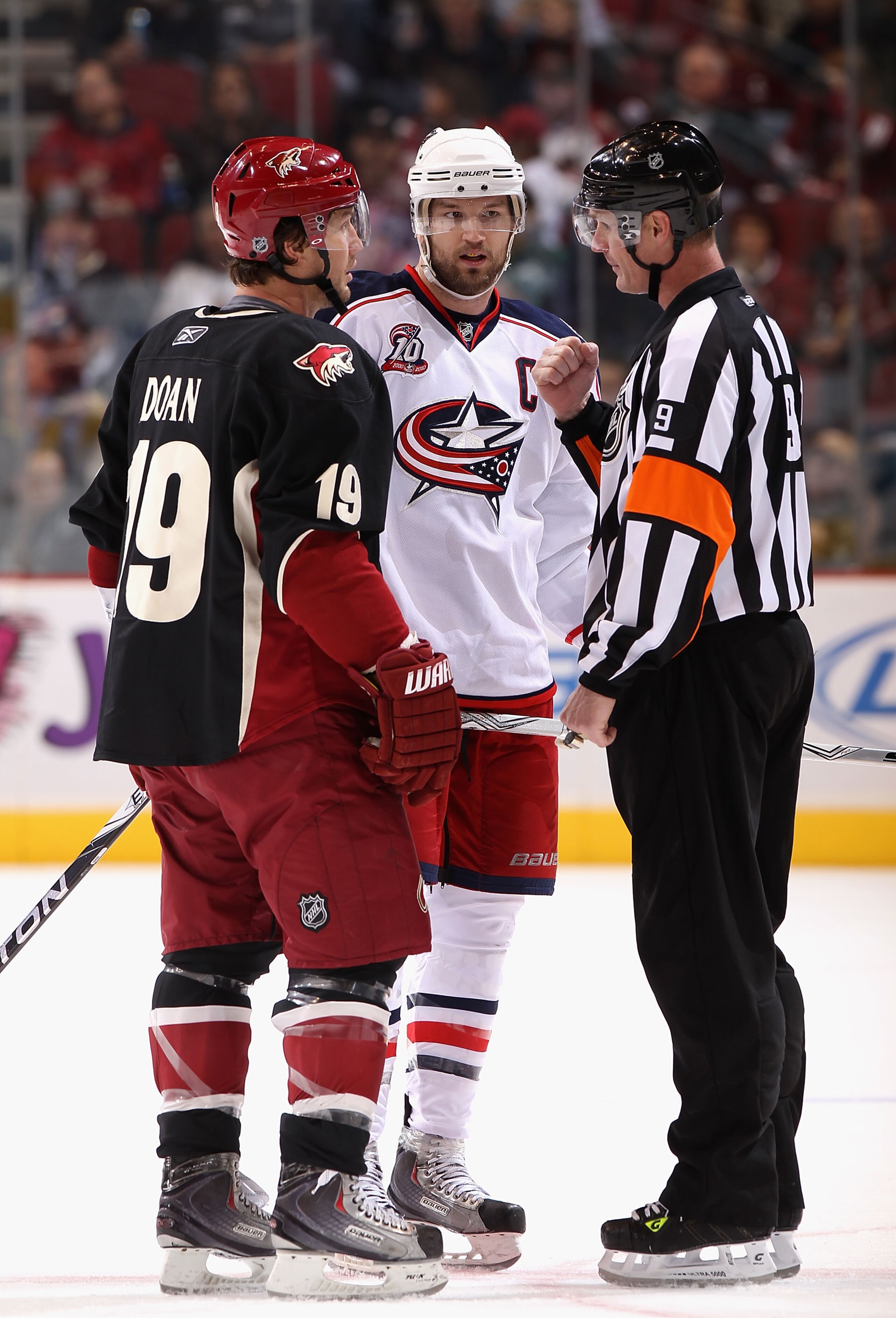 GLENDALE, AZ - JANUARY 04: Rick Nash #61 of the Columbus Blue Jackets and Shane Doan #19 of the Phoenix Coyotes talk with referee Dan O'Rourke during the NHL game at Jobing.com Arena on January 4, 2011 in Glendale, Arizona. The Coyotes defeated the Blue GLENDALE, AZ - JANUARY 04: Rick Nash #61 of the Columbus Blue Jackets and Shane Doan #19 of the Phoenix Coyotes talk with referee Dan O'Rourke during the NHL game at Jobing.com Arena on January 4, 2011 in Glendale, Arizona. The Coyotes defeated the Blue