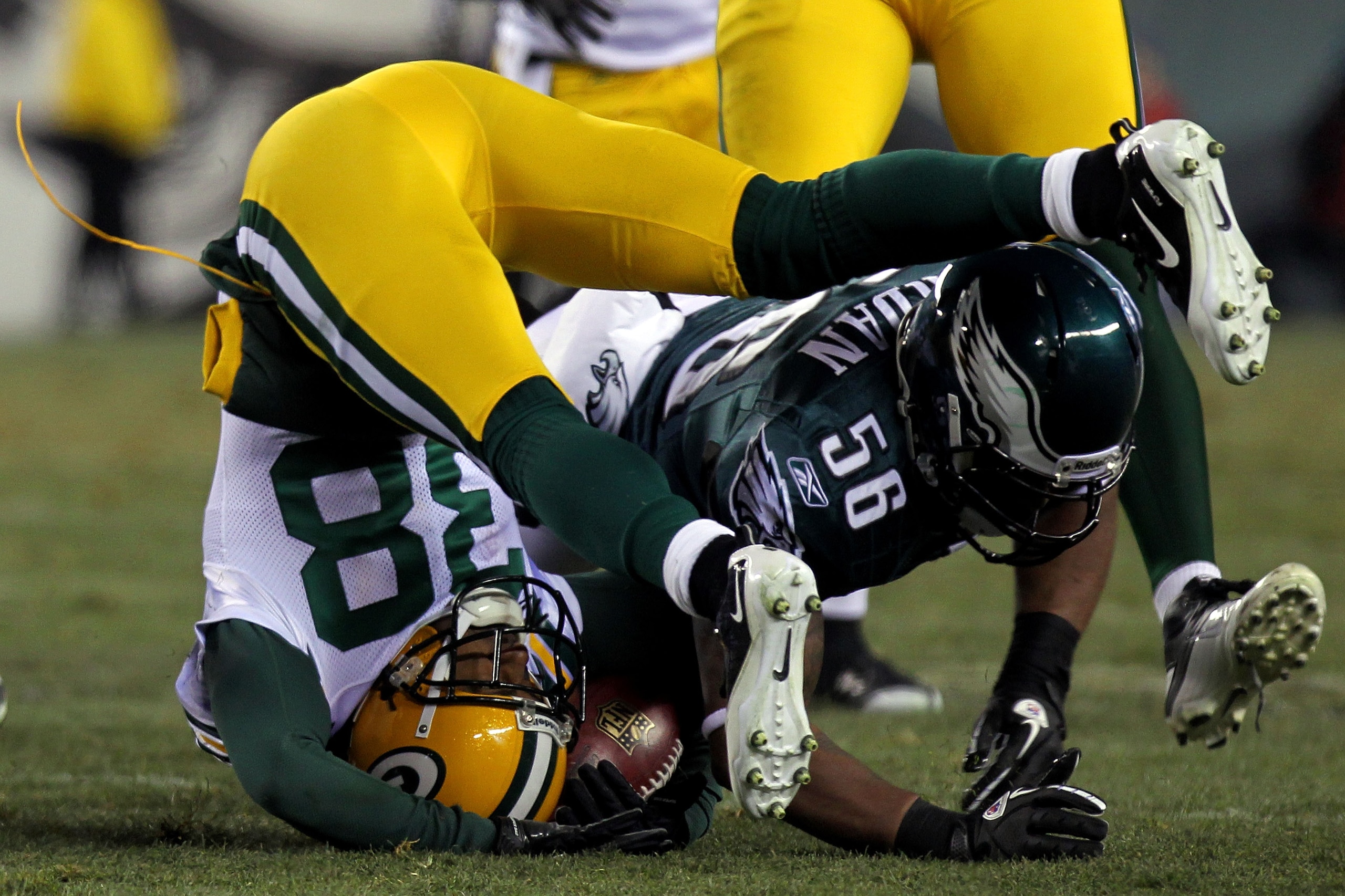 PHILADELPHIA, PA - JANUARY 09:  Akeem Jordan #56 of the Philadelphia Eagles tackles Tramon Williams #38 of the Green Bay Packers during the 2011 NFC wild card playoff game at Lincoln Financial Field on January 9, 2011 in Philadelphia, Pennsylvania.  (Phot