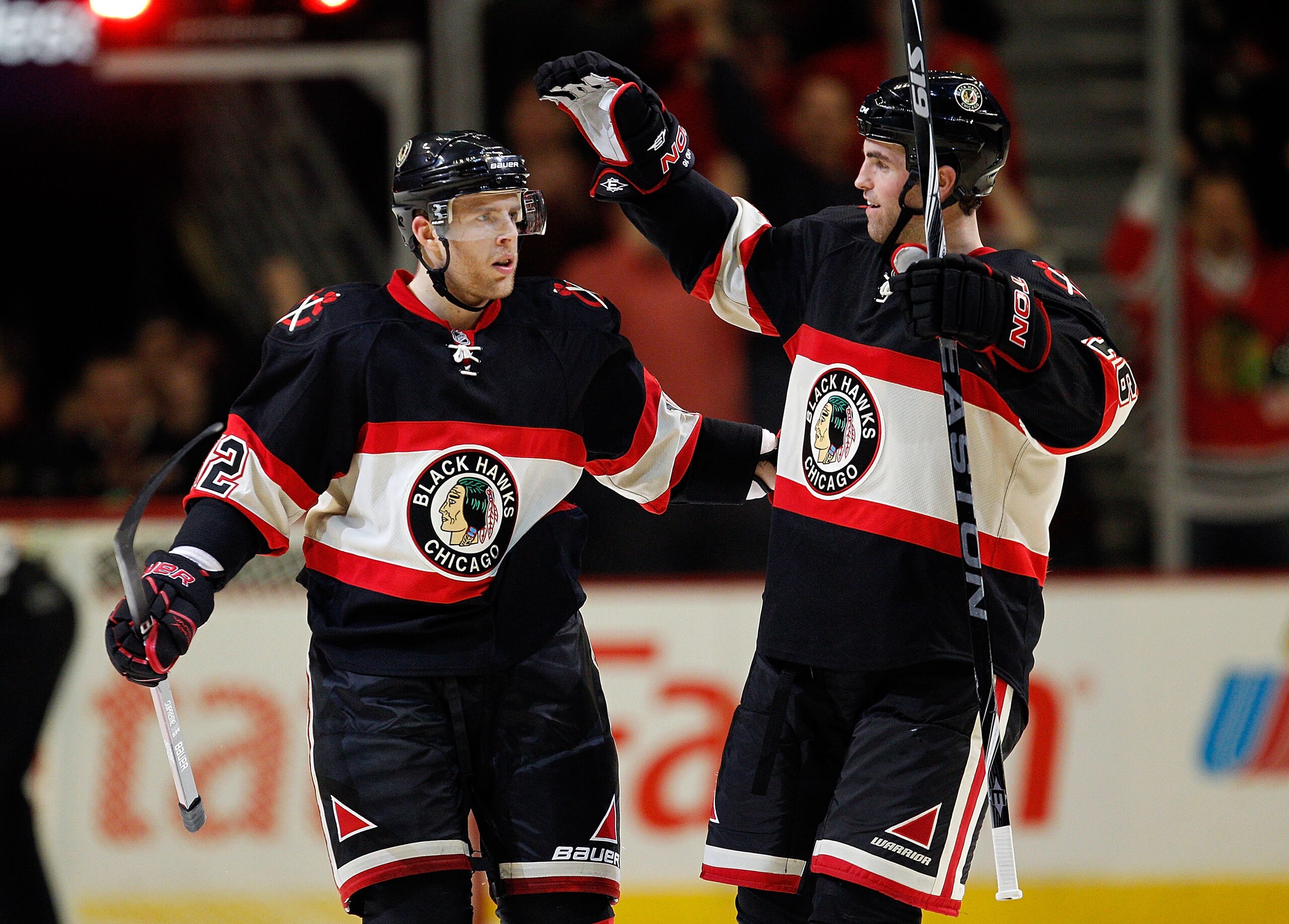 CHICAGO - FEBRUARY 10: Kris Versteeg #32 (L) and Andrew Ladd #16 of the Chicago Blackhawks celebrate after Versteeg's winning goal against the Dallas Stars at the United Center on February 9, 2010 in Chicago, Illinois. The Blackhawks defeated the Stars 4-