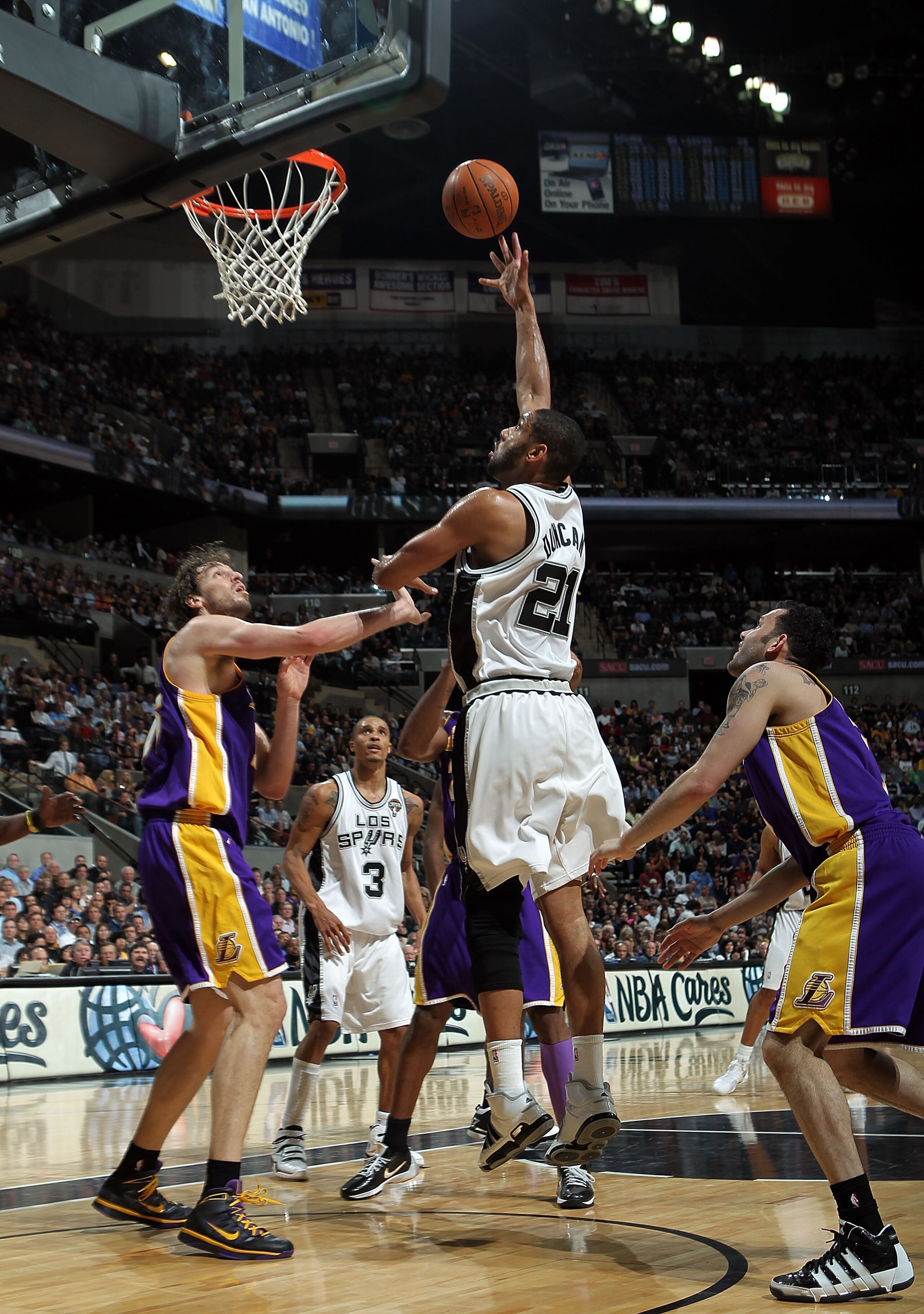 SAN ANTONIO - MARCH 24: Forward Tim Duncan #21 of the San Antonio Spurs takes a shot against Pau Gasol #16 of the Los Angeles Lakers at AT&T Center on March 24, 2010 in San Antonio, Texas. NOTE TO USER: User expressly acknowledges and agrees that, by down
