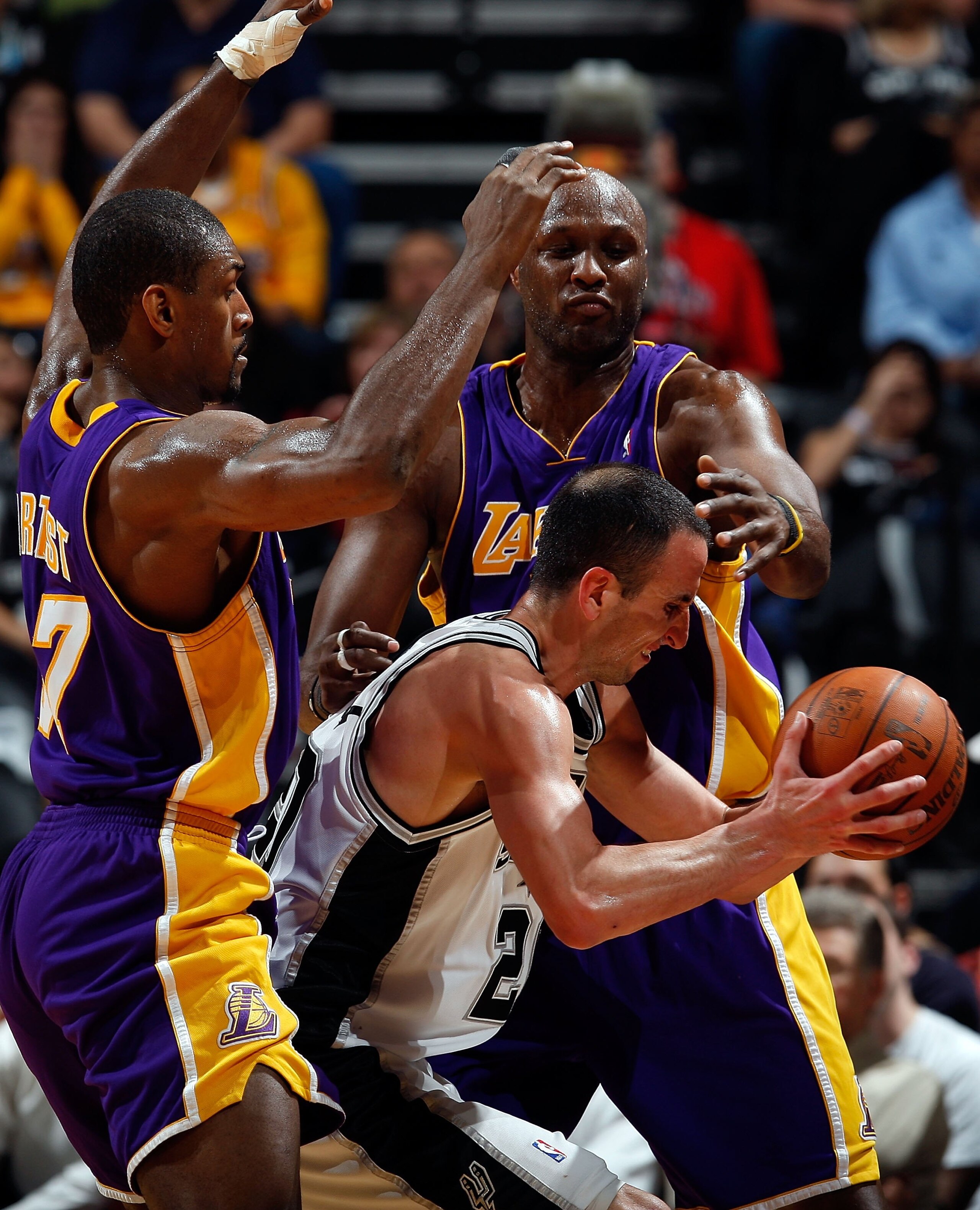 SAN ANTONIO - MARCH 24:  Guard Manu Ginobili #21 of the San Antonio Spurs is defended by Ron Artest and Lamar Odom of the Los Angeles Lakers at AT&T Center on March 24, 2010 in San Antonio, Texas.  NOTE TO USER: User expressly acknowledges and agrees that