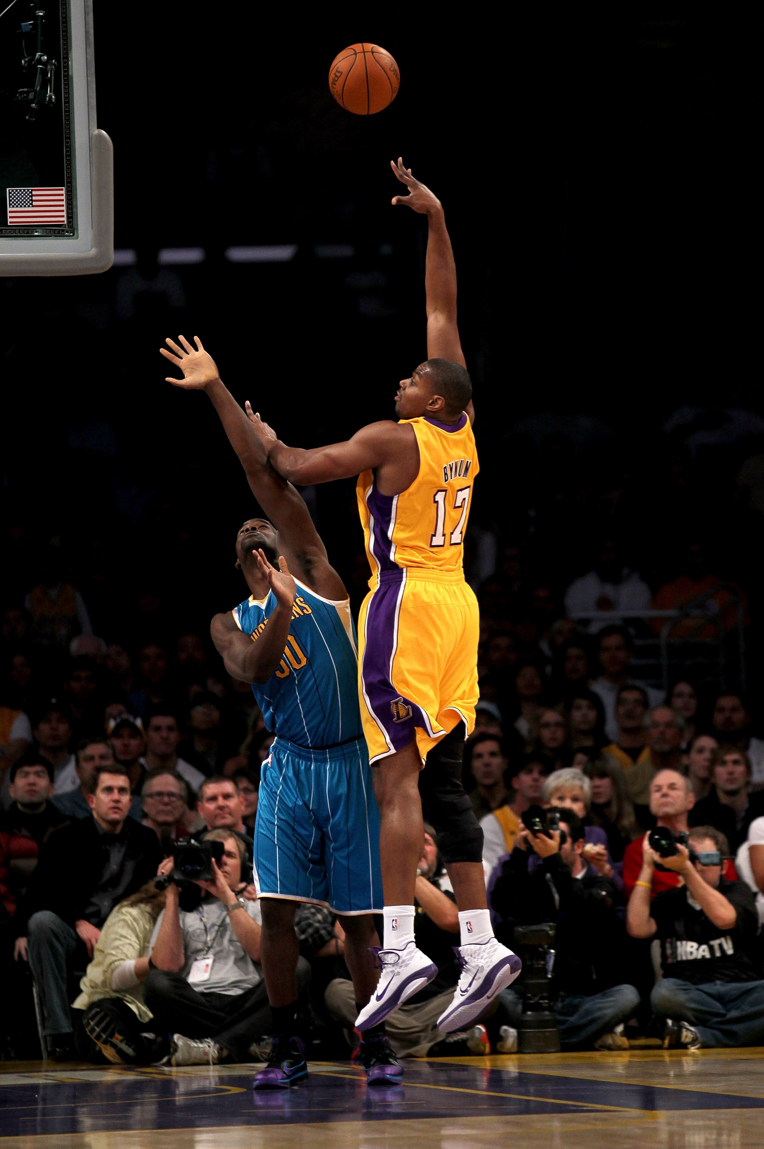 LOS ANGELES, CA - JANUARY 7:  Andrew Bynum #17 of the Los Angeles Lakers shoots over Emeka Okafor #50 of the New Orleans Hornets at Staples Center on January 7, 2011 in Los Angeles, California.  NOTE TO USER: User expressly acknowledges and agrees that, b