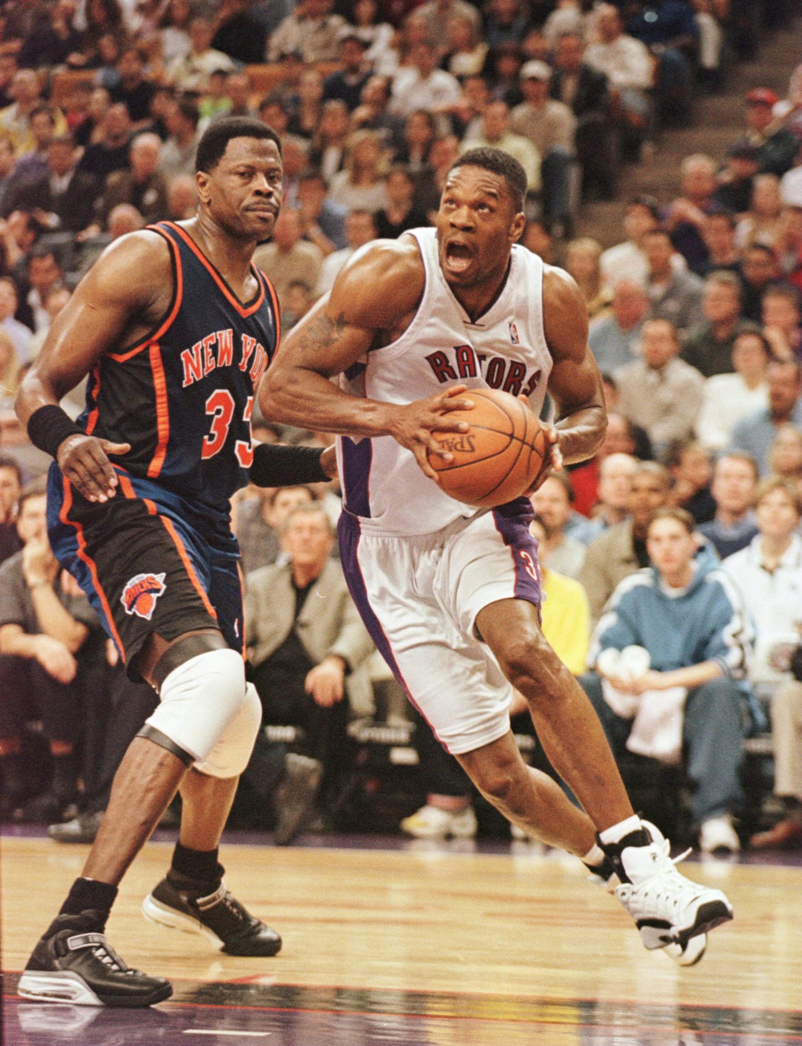 30 Apr 2000:  Forward Antonio Davis #33 of the Toronto Raptors drives to the basket past center Patrick Ewing #33 of the New York Knicks in Game 3 of the NBA First Round playoffs at the Air Canada Center in Toronto, Ontario, Canada. The Knicks won the gam