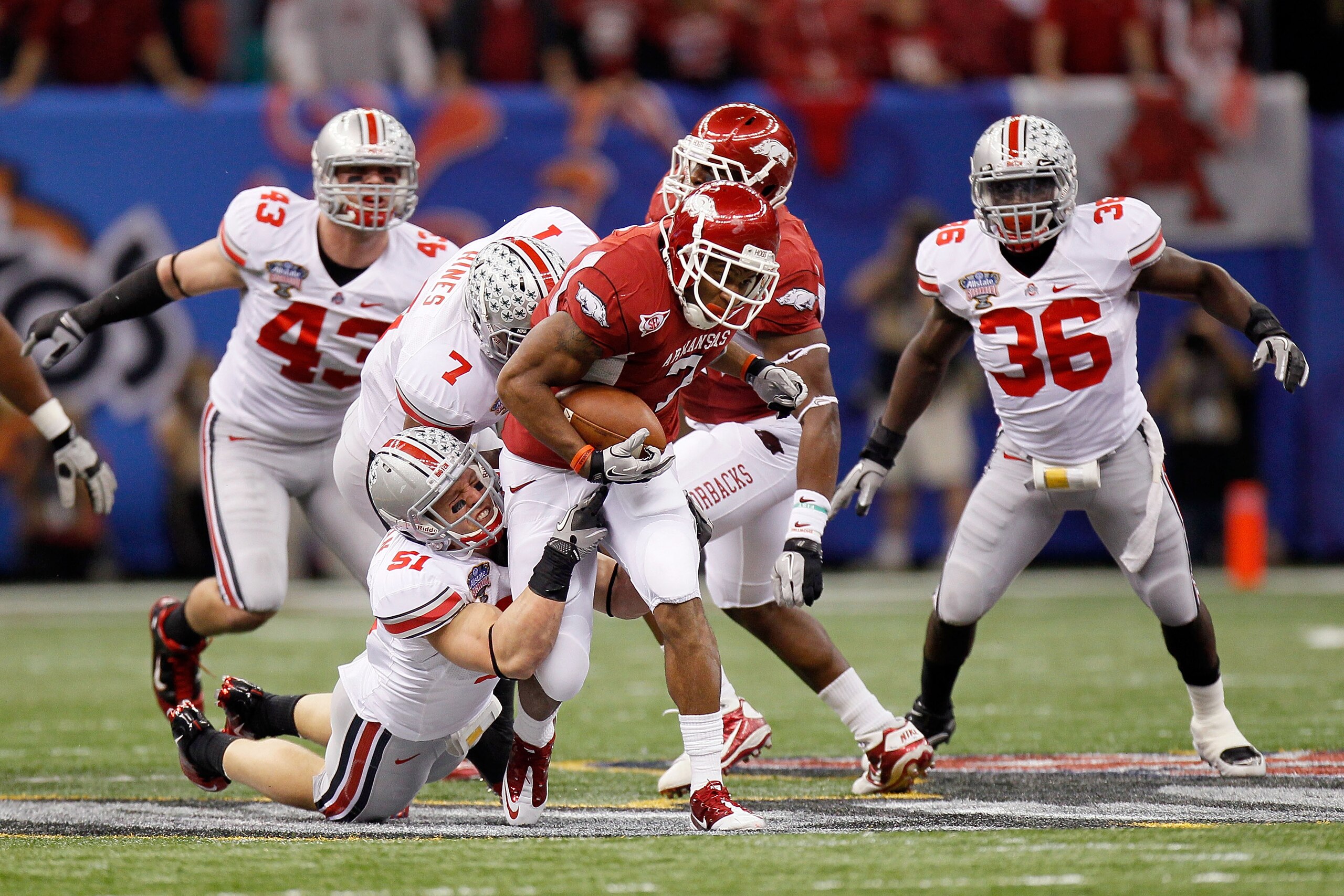 NEW ORLEANS, LA - JANUARY 04:  Knile Davis #7 of the Arkansas Razorbacks runs the ball in the first half against Ross Homan #51 of the Ohio State Buckeyes  during the Allstate Sugar Bowl at the Louisiana Superdome on January 4, 2011 in New Orleans, Louisi