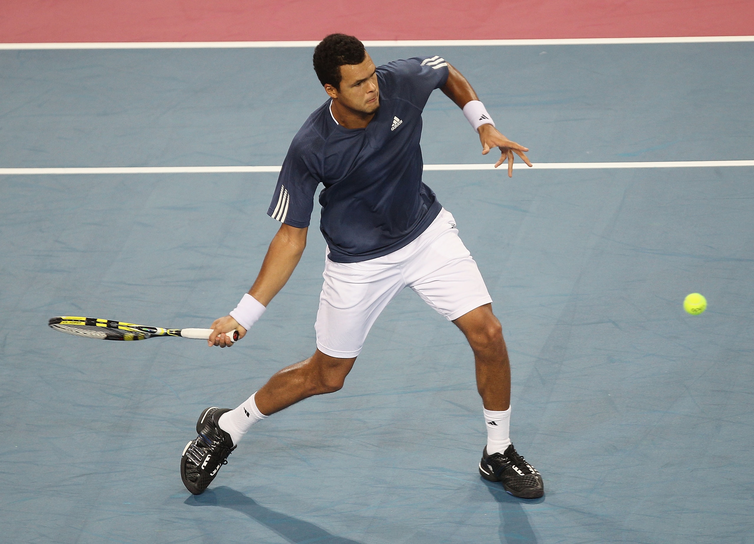 MONTPELLIER, FRANCE - OCTOBER 30:  Jo-Wilfried Tsonga of France plays a forehand during his semi final match against Gael Monfils of France during day six of the Open Sud de France at the Arena on October 30, 2010 in Montpellier, France.  (Photo by Hamish