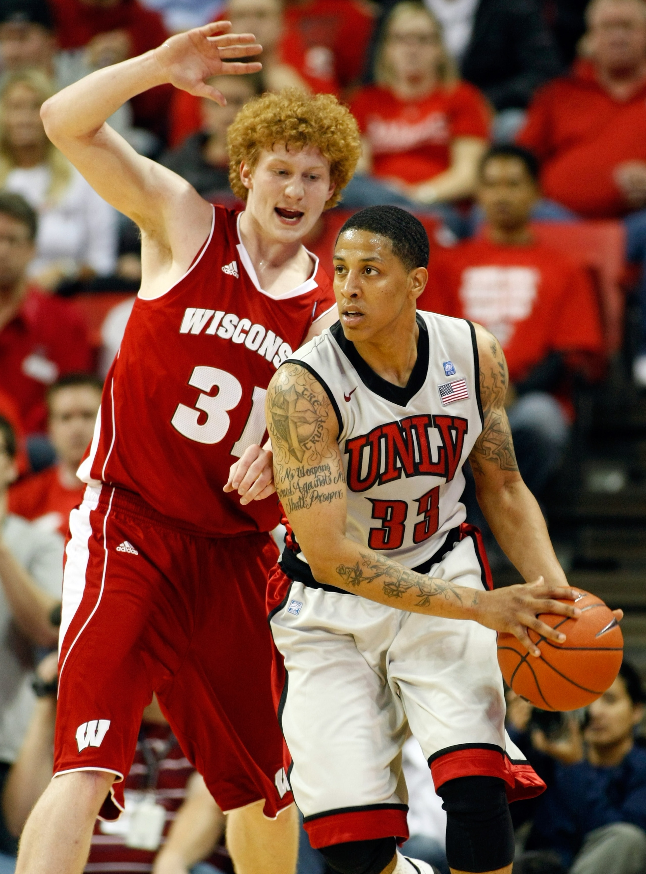LAS VEGAS - NOVEMBER 20:  Tre'Von Willis #33 of the UNLV Rebels looks to pass as Mike Bruesewitz #31 of the Wisconsin Badgers defends during their game at the Thomas & Mack Center November 20, 2010 in Las Vegas, Nevada. UNLV won 68-65.  (Photo by Ethan Mi