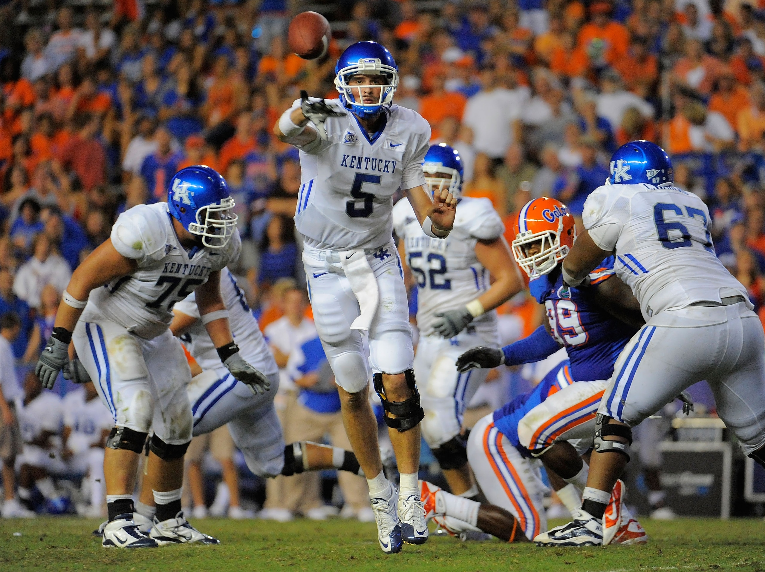 GAINESVILLE, FL - SEPTEMBER 25:  Quarterback Mike Hartline #5 of the Kentucky Wildcats throws a pass against the Florida Gators at Ben Hill Griffin Stadium on September 25, 2010 in Gainesville, Florida. Florida defeated Kentucky 48-14 for head coach Urban