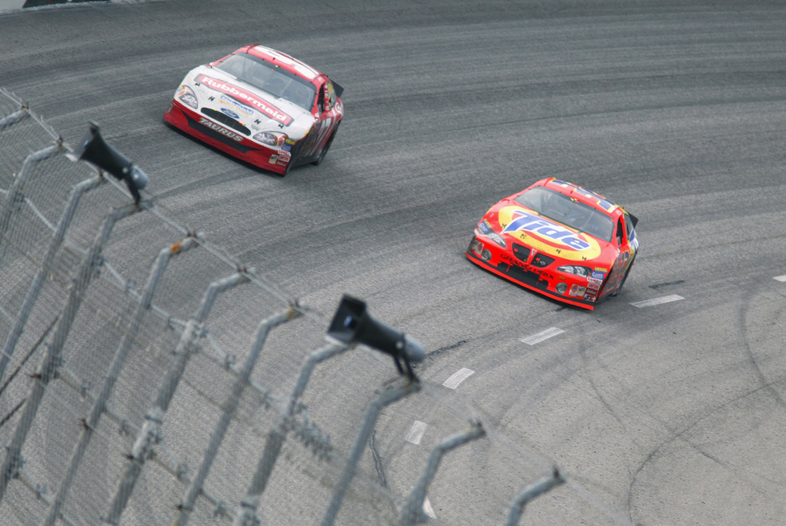 DARLINGTON, SC - MARCH 16:  Eventual winner Ricky Craven, driver of the #32 Tide Pontiac, passes Kurt Busch, driver of the #97 Rubbermain Ford, on the final lap of the NASCAR Carolina Dodge Dealers 400 on March 16, 2003 at Darlington Raceway in Darlington