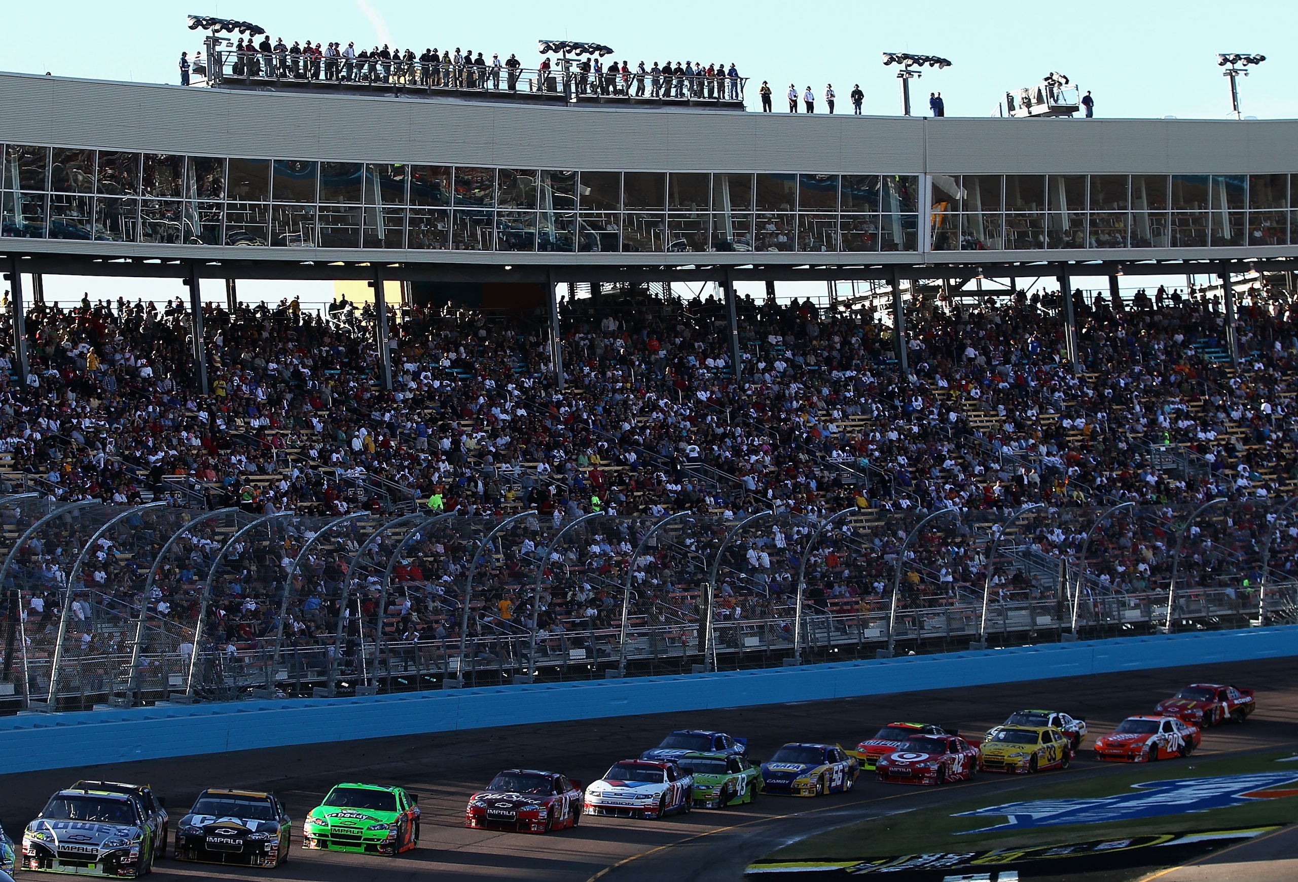 AVONDALE, AZ - NOVEMBER 14:  Jimmie Johnson, driver of the #48 Lowe's Chevrolet, leads a pack of cars during the NASCAR Sprint Cup Series Kobalt Tools 500 at Phoenix International Raceway on November 14, 2010 in Avondale, Arizona.  (Photo by Christian Pet