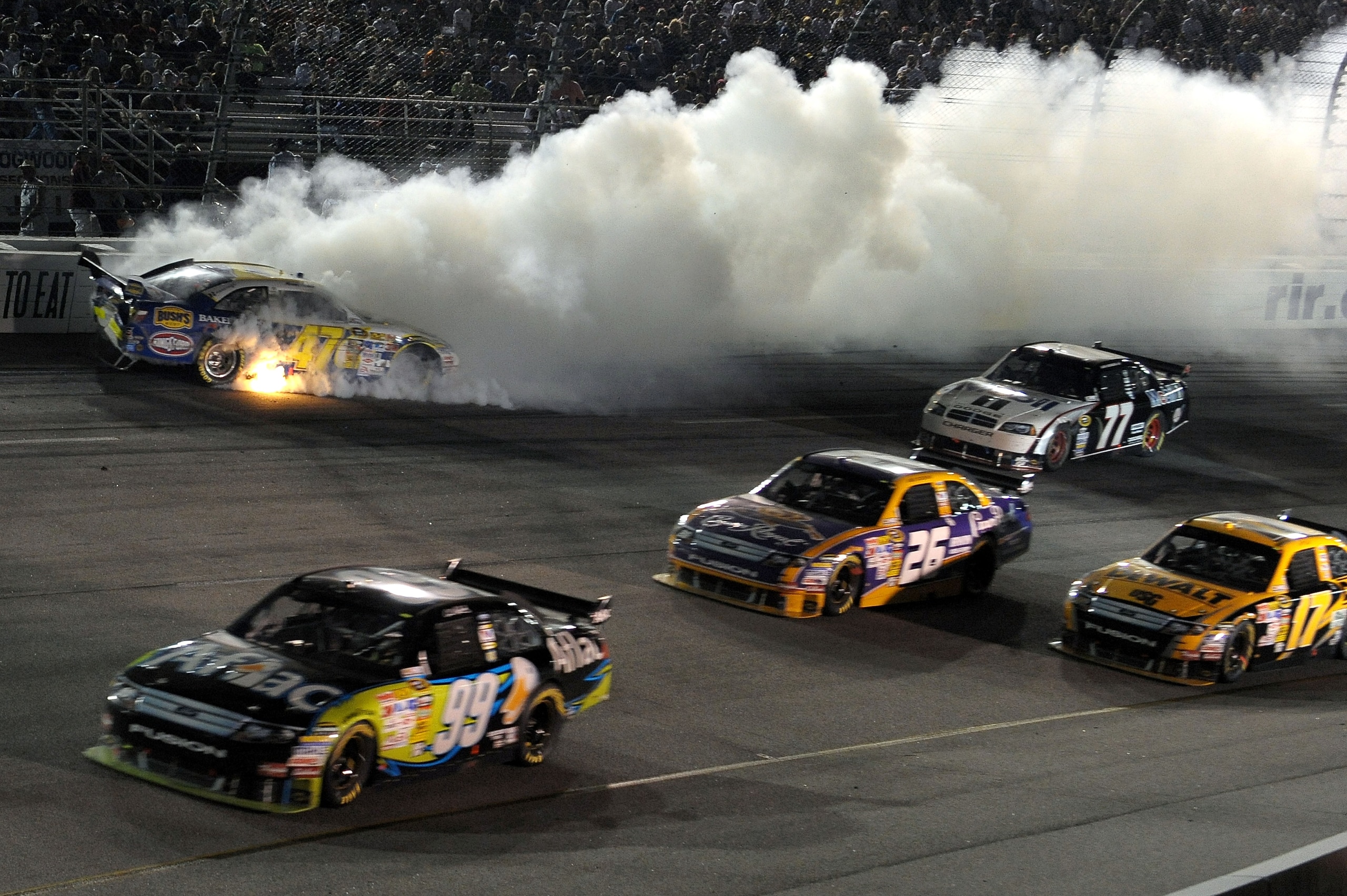 RICHMOND, VA - MAY 02:  Marcos Ambros, driver of the #47 Bush's Best Baked Beans/Kingsford/Clorox Toyota crashes in turn 2 during the NASCAR Sprint Cup Series Crown Royal Presents the Russ Friedman 400 at Richmond International Raceway on May 2, 2009 in R