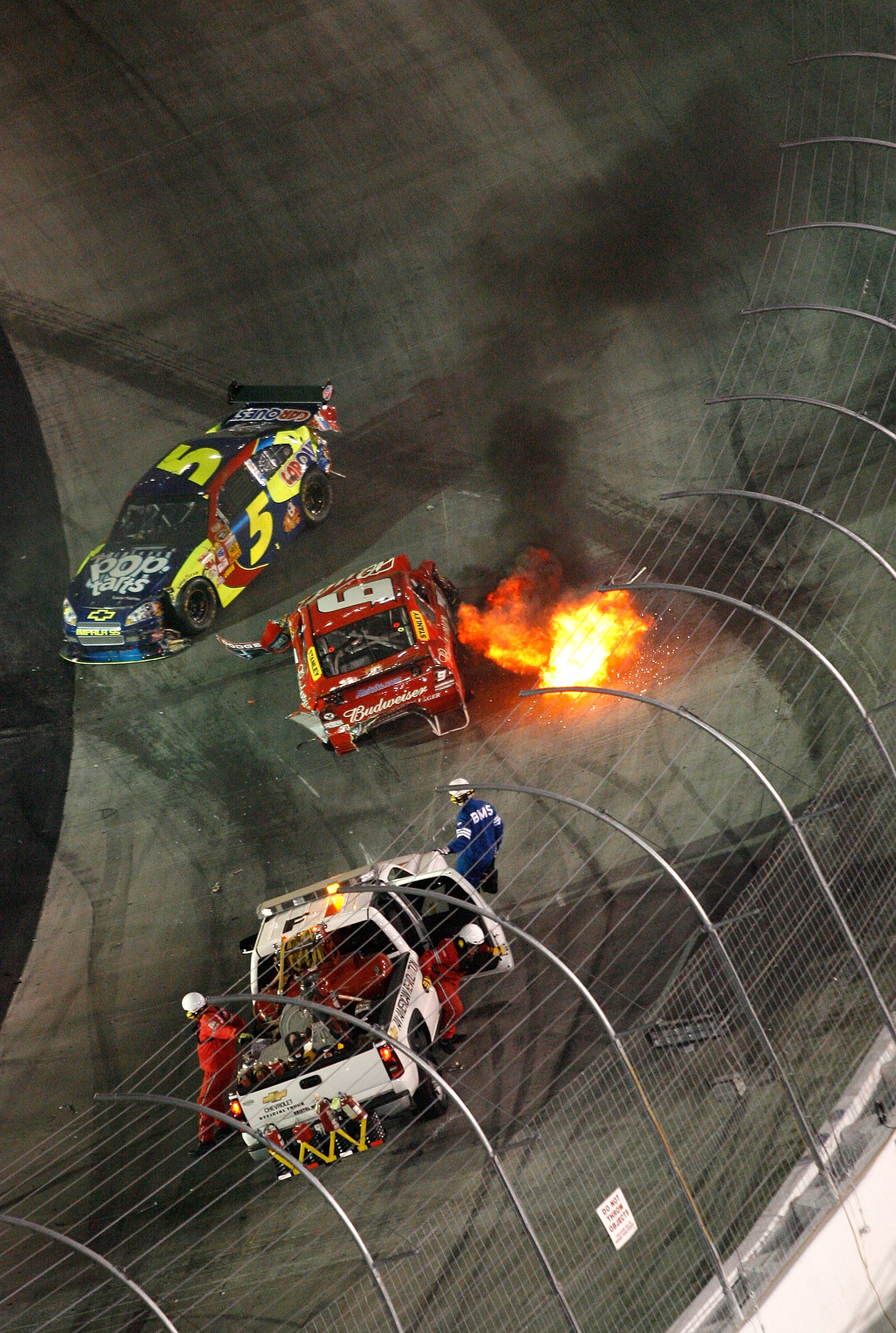 BRISTOL, TN - AUGUST 23:  Flames come from the side of the car of Kasey Kahne, driver of the #9 Budweiser Dodge, after crashing during the NASCAR Sprint Cup Series Sharpie 500 at Bristol Motor Speedway on August 23, 2008 in Bristol, Tennessee.  (Photo by