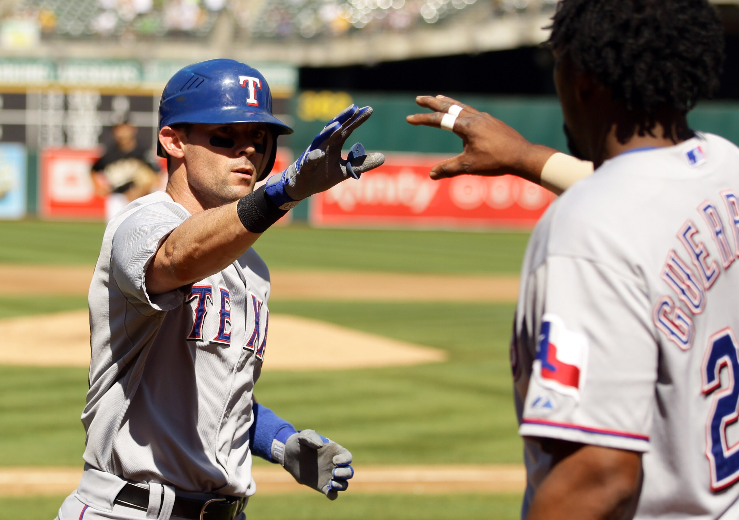 OAKLAND, CA - SEPTEMBER 25:  Michael Young #10 of the Texas Rangers is congratulated by Vladimir Guerrero #27 after he hit a solo home run to tie the game in the third inning against the Oakland Athletics at the Oakland-Alameda County Coliseum on Septembe