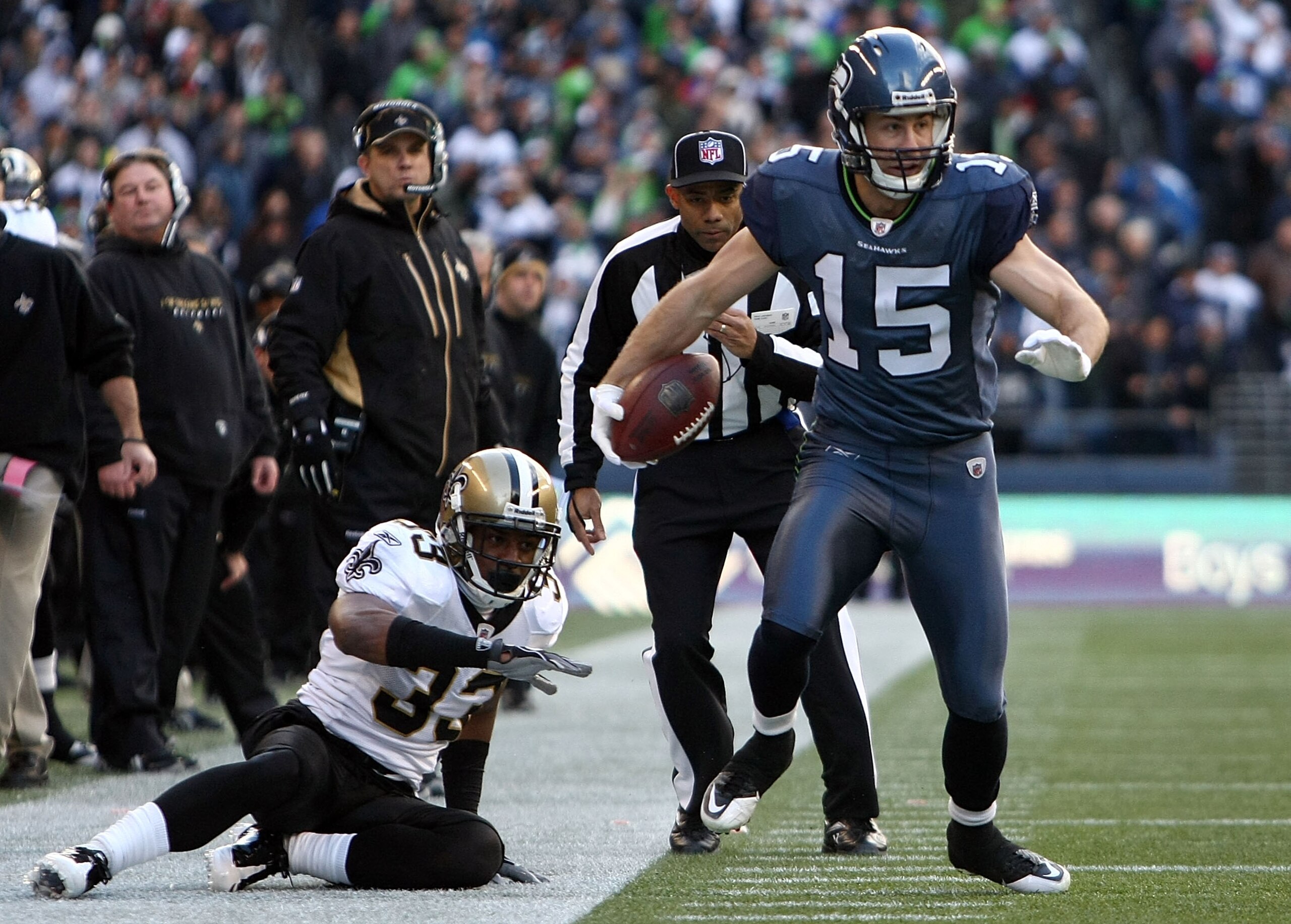 SEATTLE, WA - JANUARY 08:  Brandon Stokley #15 of the Seattle Seahawks attempts to avoid a tackle from Jabari Greer #33 of the New Orleans Saints as he runs for five-yards after the catch in the first quarter during the 2011 NFC wild-card playoff game at