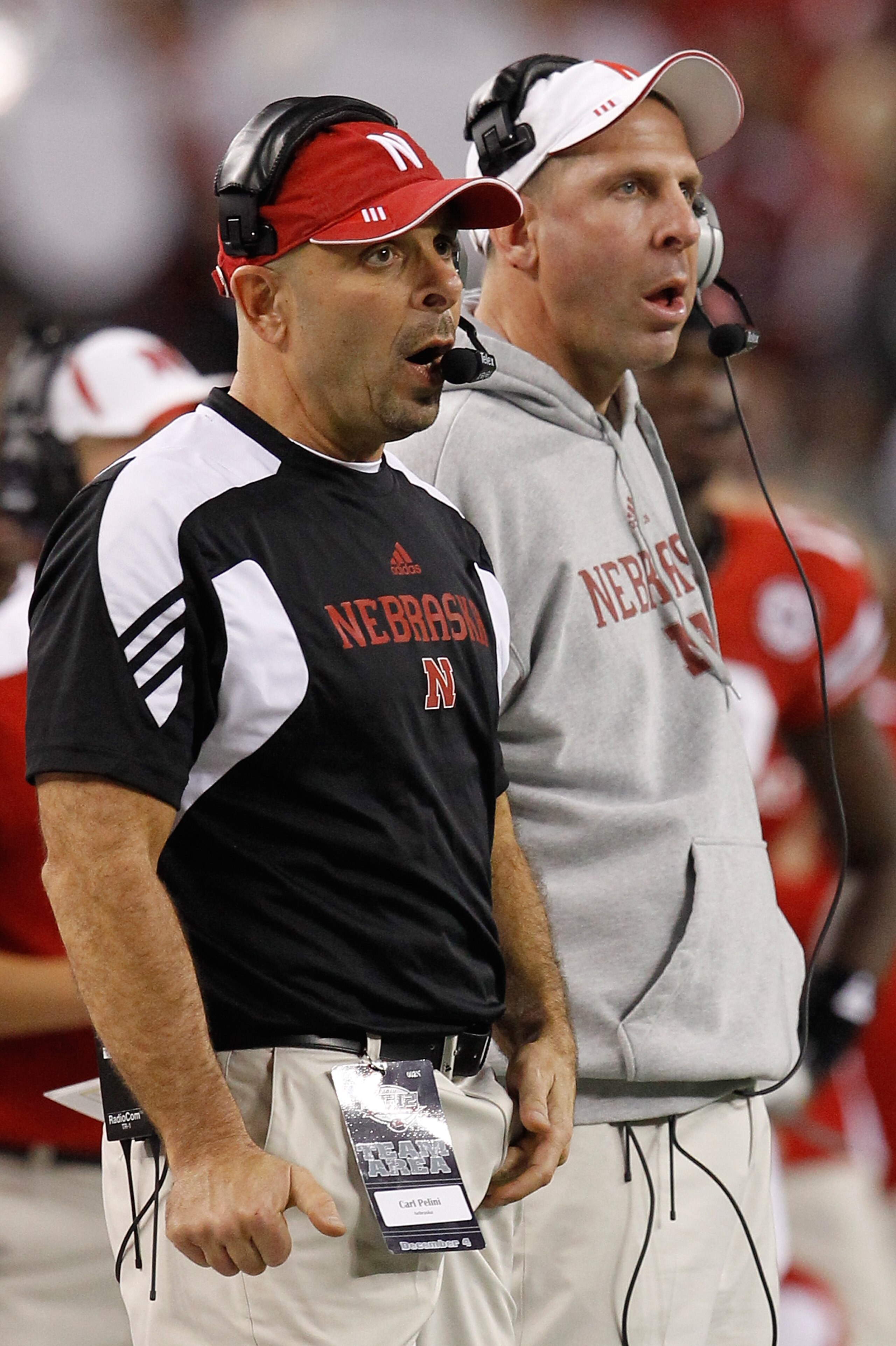 ARLINGTON, TX - DECEMBER 04: Head coach Bo Pelini (R) of the Nebraska Cornhuskers and defensive coordinator Carl Pelini lead their team against the Oklahoma Sooners at Cowboys Stadium on December 4, 2010 in Arlington, Texas. The Sooners beat the Cornhusk ARLINGTON, TX - DECEMBER 04: Head coach Bo Pelini (R) of the Nebraska Cornhuskers and defensive coordinator Carl Pelini lead their team against the Oklahoma Sooners at Cowboys Stadium on December 4, 2010 in Arlington, Texas. The Sooners beat the Cornhusk