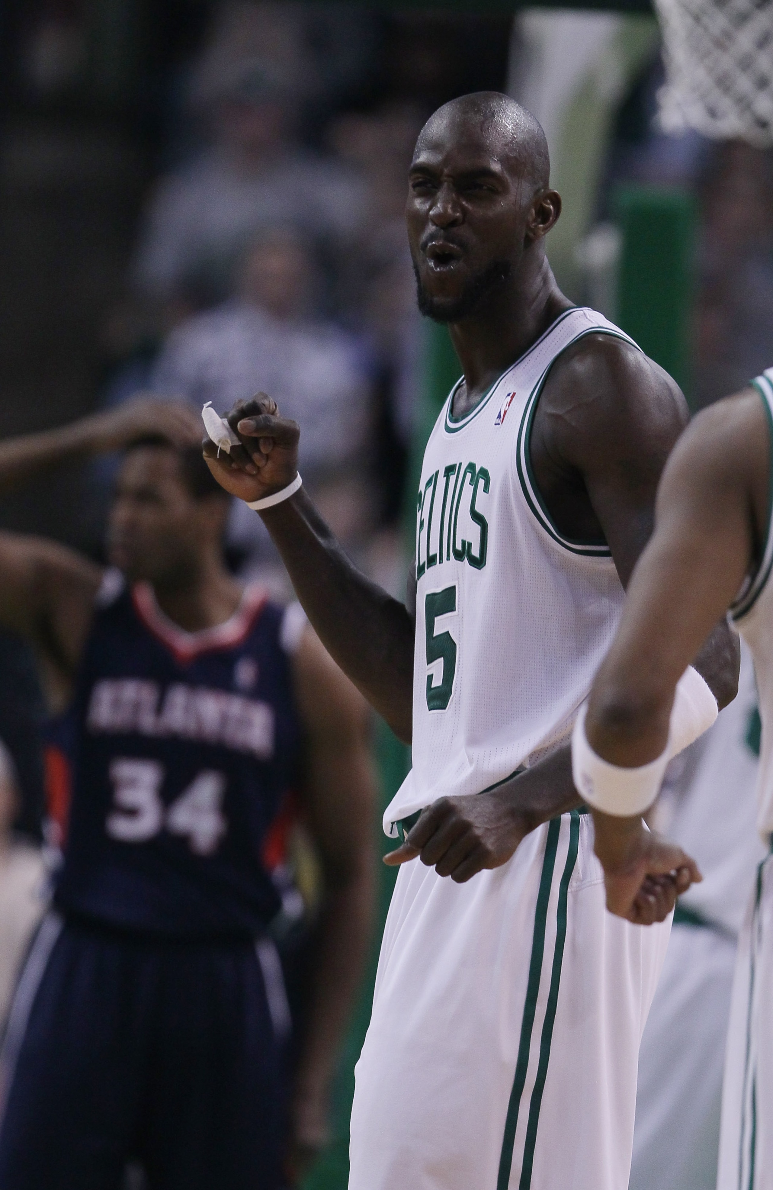 BOSTON, MA - DECEMBER 16:  Kevin Garnett #5 of the Boston Celtics celebrates a basket as Jason Collins #34 of the Atlanta Hawks reacts in the second half on December 16, 2010 at the TD Garden in Boston, Massachusetts. The Celtics defeated the Hawks 102-90