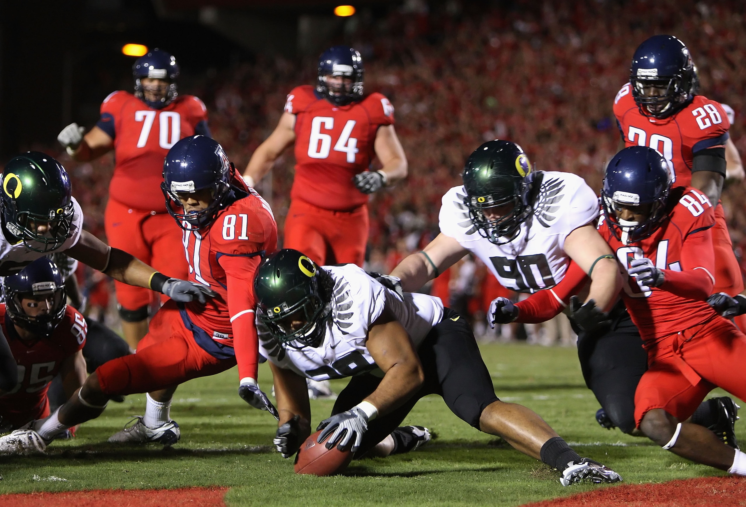 TUCSON, AZ - NOVEMBER 21:  Defensive end Will Tukuafu #39 of the Oregon Ducks recovers a fumble from David Roberts #81 of the Arizona Wildcats in the endzone during the college football game at Arizona Stadium on November 21, 2009 in Tucson, Arizona. The