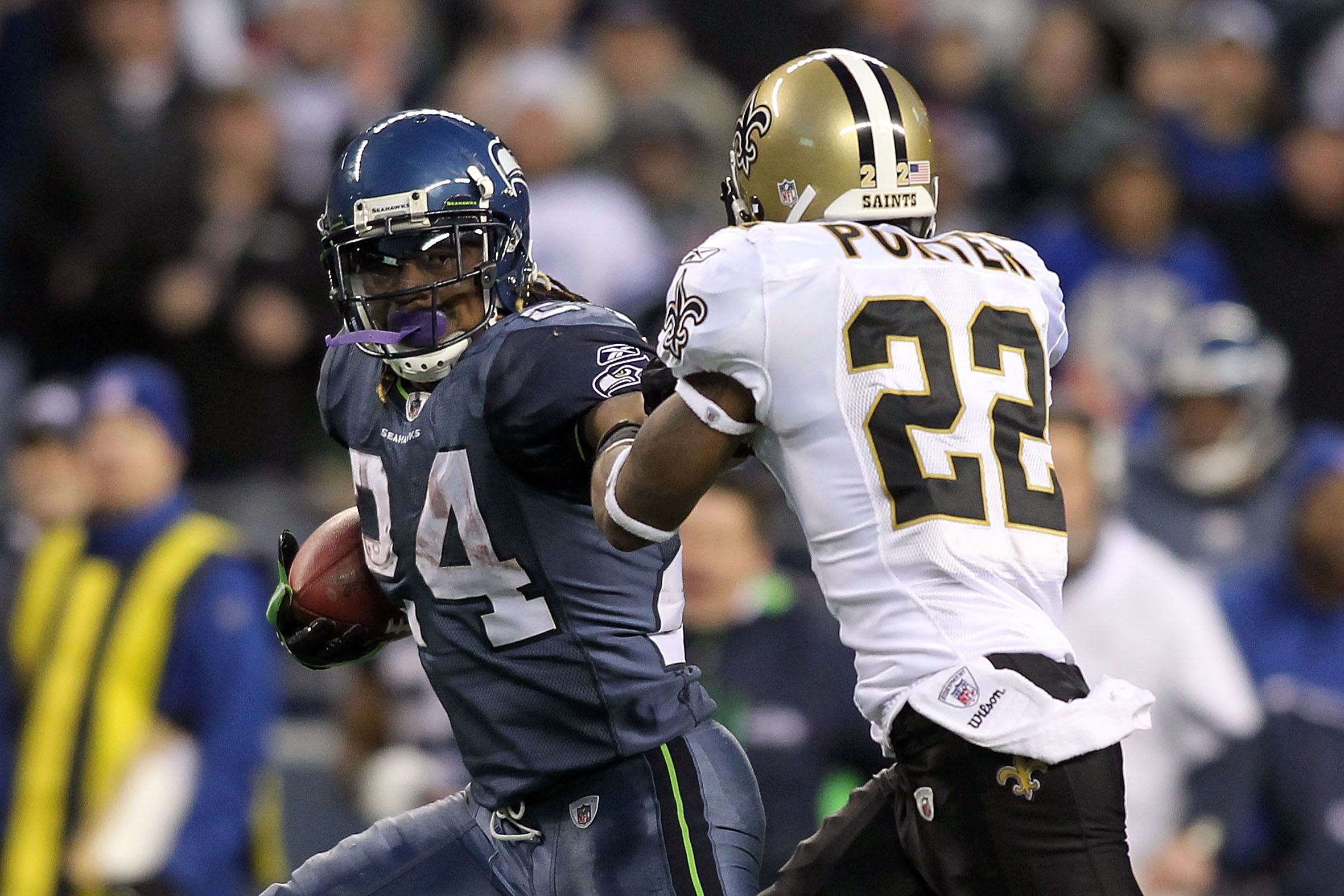 SEATTLE, WA - JANUARY 08: Running back Marshawn Lynch #24 of the Seattle Seahawks runs for a 67-yard touchdown run in the fourth quarter against Tracy Porter #22 of the New Orleans Saints during the 2011 NFC wild-card playoff game at Qwest Field on Janua SEATTLE, WA - JANUARY 08: Running back Marshawn Lynch #24 of the Seattle Seahawks runs for a 67-yard touchdown run in the fourth quarter against Tracy Porter #22 of the New Orleans Saints during the 2011 NFC wild-card playoff game at Qwest Field on Janua