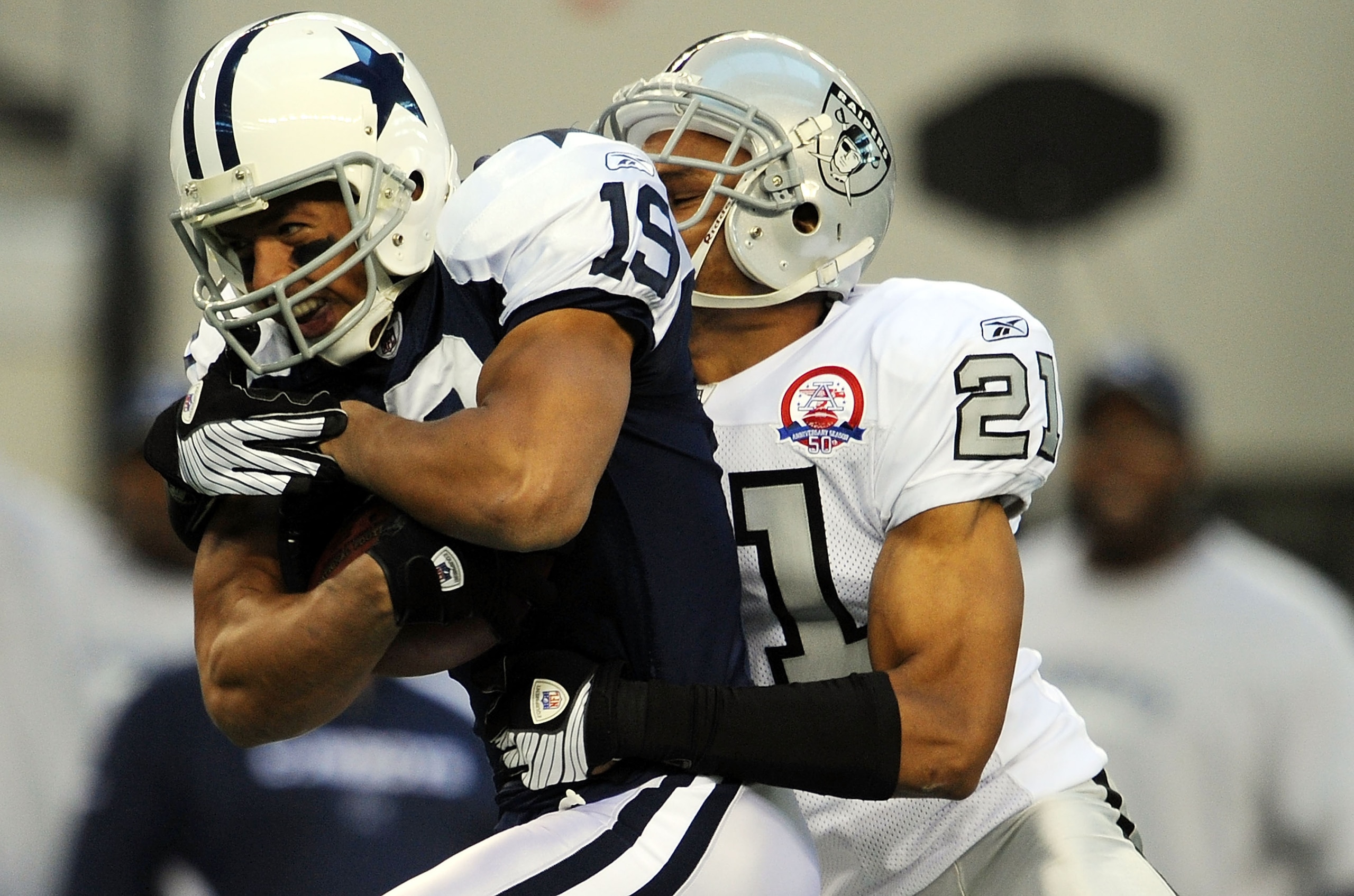 ARLINGTON, TX - NOVEMBER 26:  Wide receiver Miles Austin #19 of the Dallas Cowboys runs the ball against Nnamdi Asomugha #21 of the Oakland Raiders at Cowboys Stadium on November 26, 2009 in Arlington, Texas.  (Photo by Ronald Martinez/Getty Images)