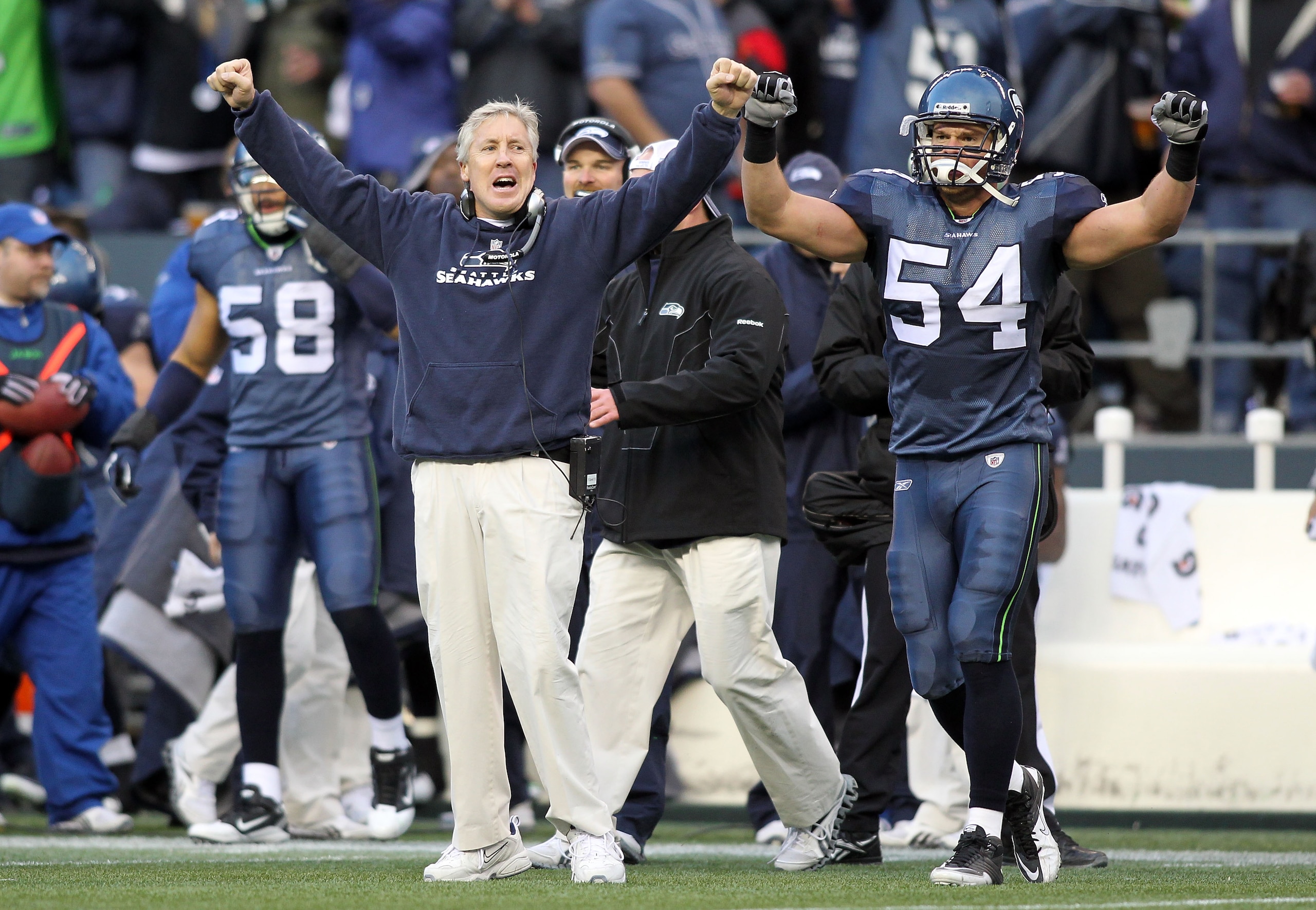 SEATTLE, WA - JANUARY 08:  Head coach Pete Carroll and Will Herring #54 of the Seattle Seahawks celebrate a fourth down stop by the Seahawks in the third quarter against the New Orleans Saints during the 2011 NFC wild-card playoff game at Qwest Field on J