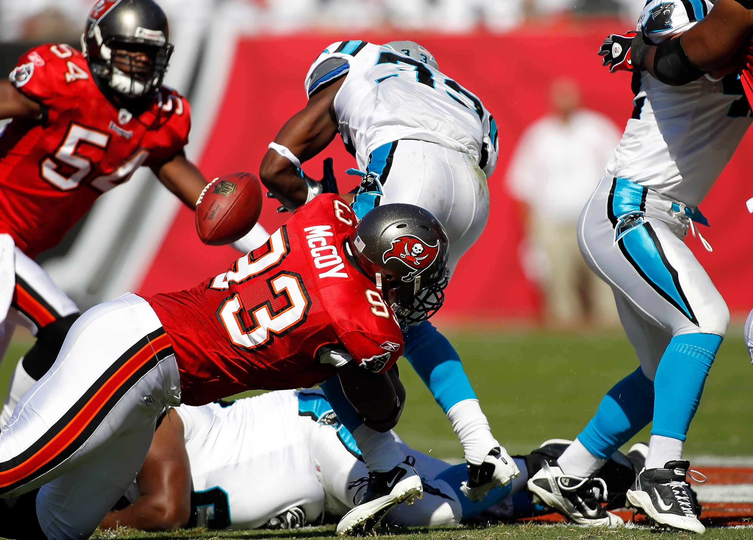 TAMPA, FL - NOVEMBER 14:  Defensive tackle Gerald McCoy #93 of the Tampa Bay Buccaneers causes running back Mike Goodson #33 of the Carolina Panthers to fumble during the game at Raymond James Stadium on November 14, 2010 in Tampa, Florida.  (Photo by J.