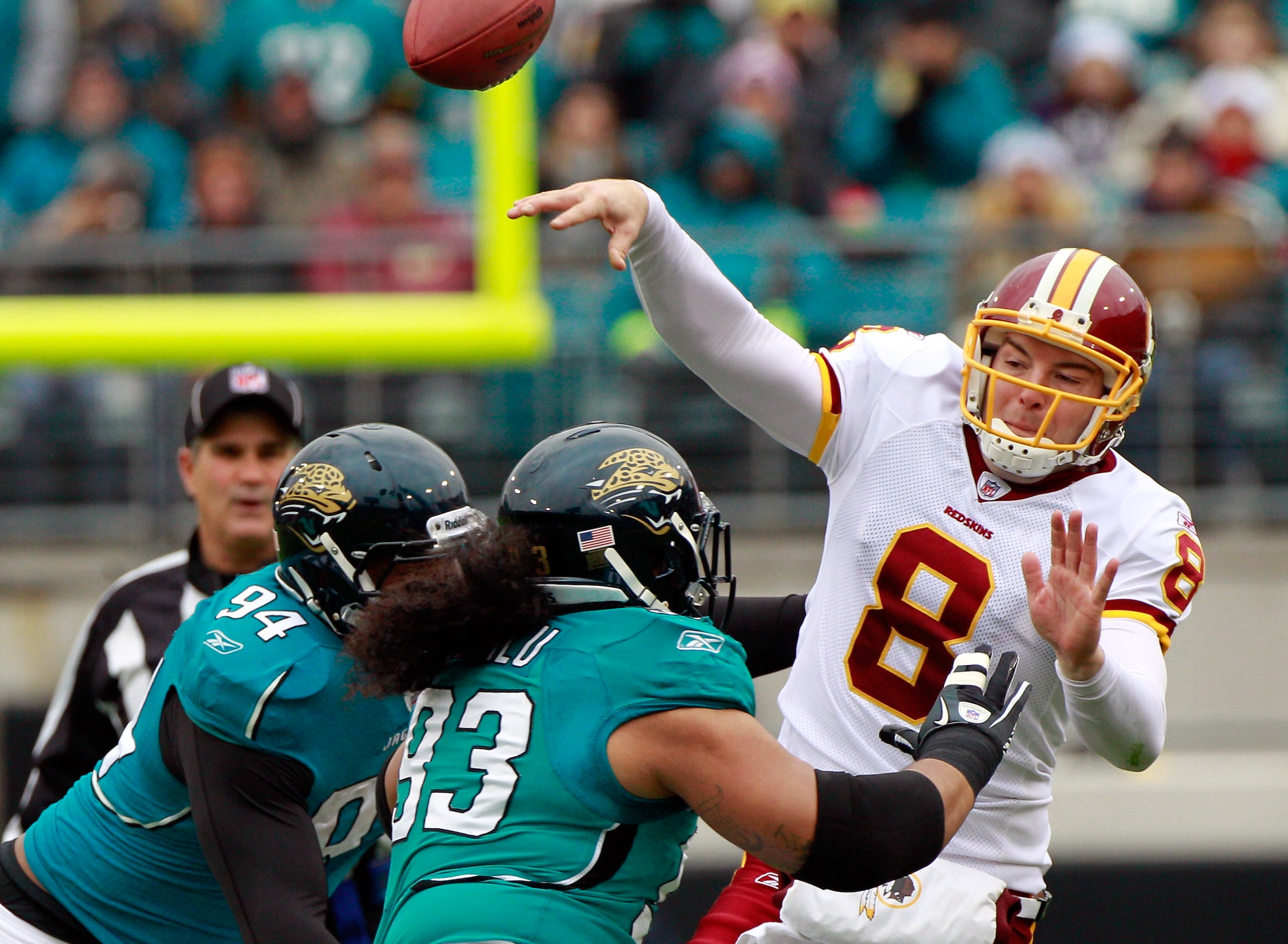 JACKSONVILLE, FL - DECEMBER 26: Quarterback Rex Grossman #8 of the Washington Redskins is pressured by Tyson Alualu #93 and Jeremy Mincey #94 of the Jacksonville Jaguars during the game at EverBank Field on December 26, 2010 in Jacksonville, Florida.  (Ph