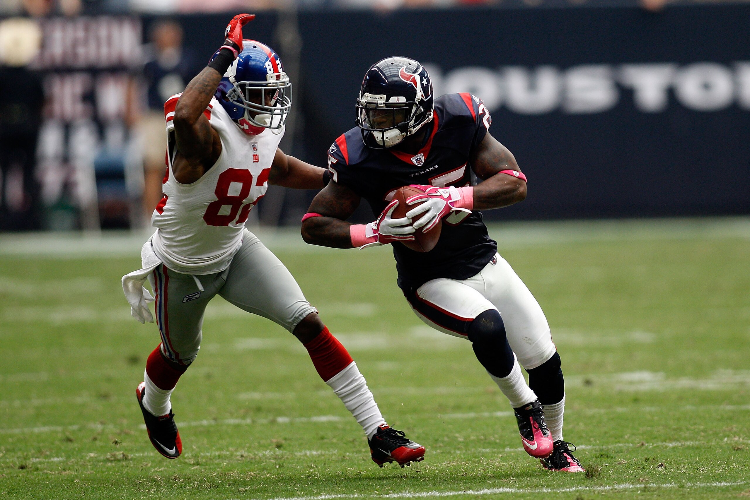 HOUSTON - OCTOBER 10:  Kareem Jackson #25 of the Houston Texans avoids a tackle after intercepting a pass  by Mario Manningham #82 of the New York Giants at Reliant Stadium on October 10, 2010 in Houston, Texas.  The Giants defeated the Texans 34-10.  (Ph