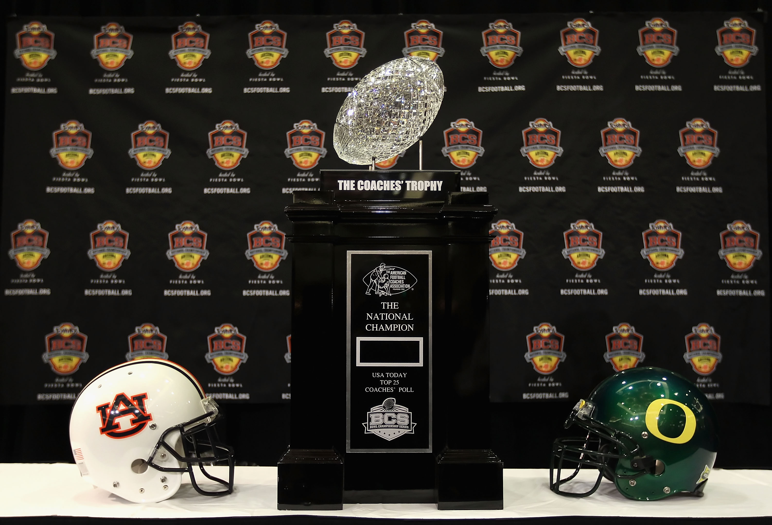 SCOTTSDALE, AZ - JANUARY 07:  The coaches trophy is displayed with helmets for the Auburn Tigers and the Oregon Ducks during Media Day for the Tostitos BCS National Championship Game at the JW Marriott Camelback Inn on January 7, 2011 in Scottsdale, Arizo