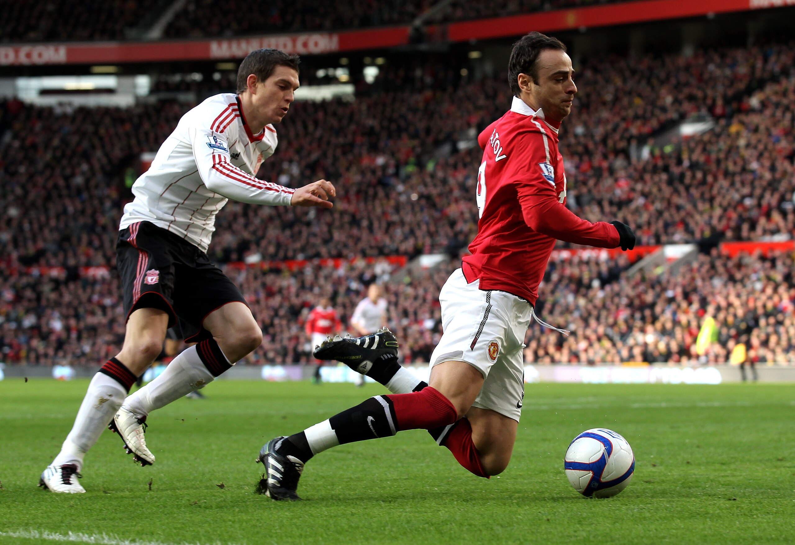 MANCHESTER, ENGLAND - JANUARY 09:  Daniel Agger of Liverpool brings down Dimitar Berbatov of Manchester United to concede a penalty during the FA Cup sponsored by E.ON 3rd round match between Manchester United and Liverpool at Old Trafford on January 9, 2