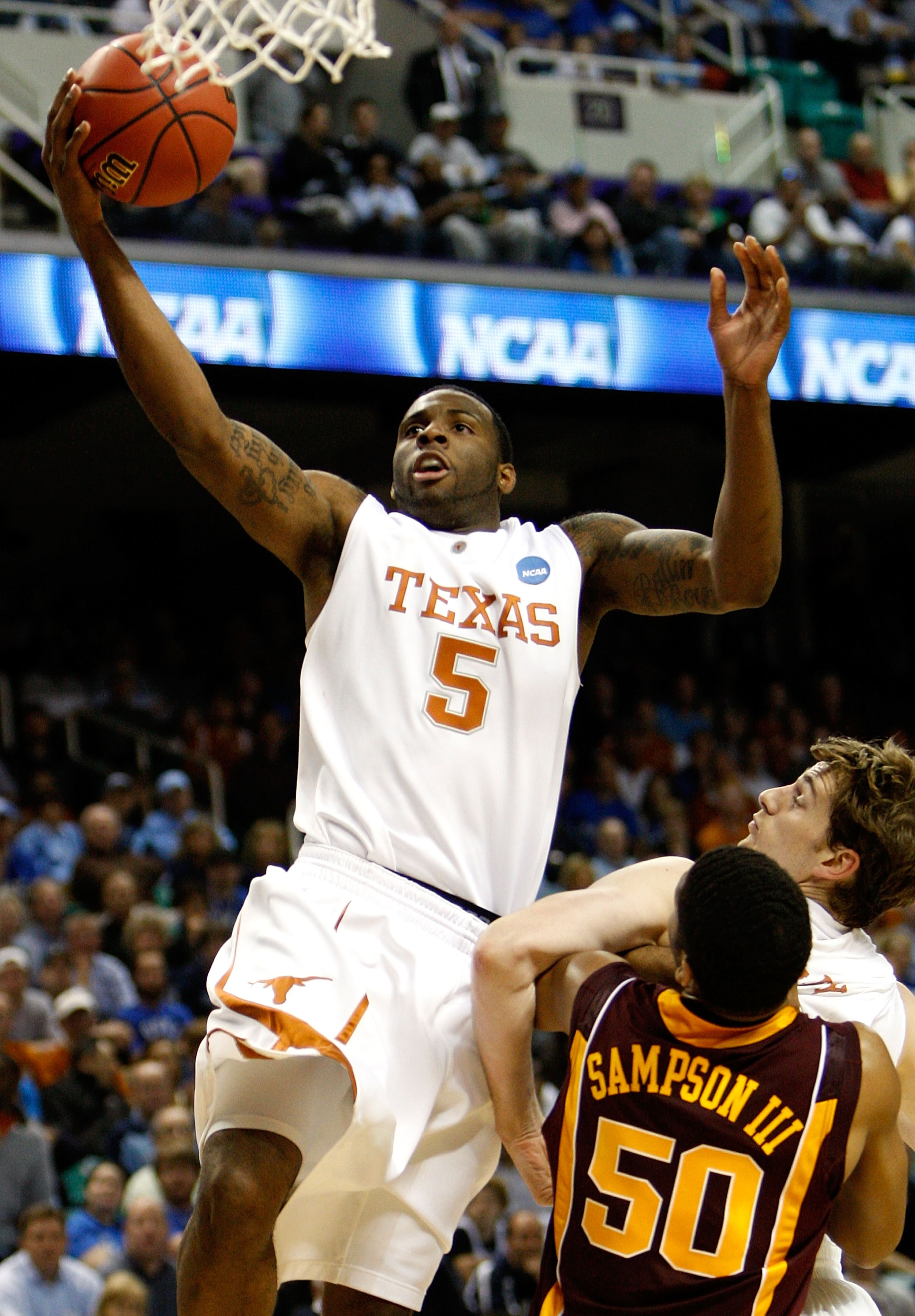 GREENSBORO, NC - MARCH 19:  Damion James #5 of the Texas Longhorns drives past Ralph Sampson III #50 of the Minnesota Golden Gophers during the first round of the NCAA Division I Men's Basketball Tournament at the Greensboro Coliseum on March 19, 2009 in