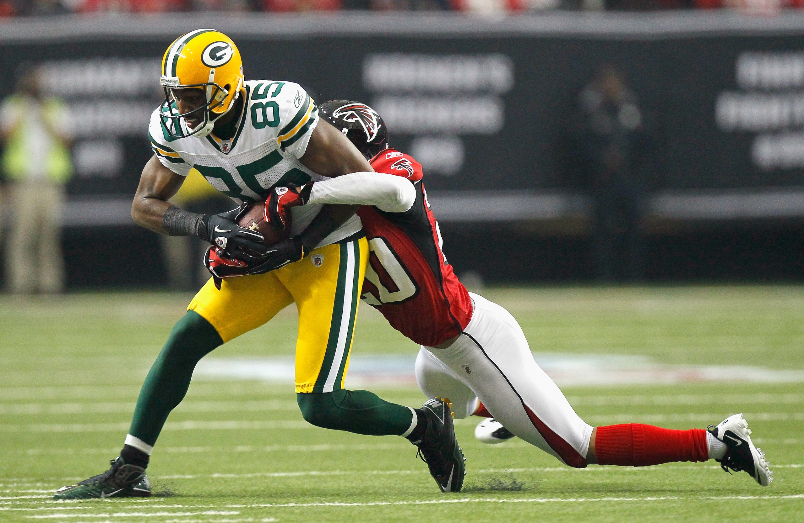 ATLANTA - NOVEMBER 28:  Brent Grimes #20 of the Atlanta Falcons tackles Greg Jennings #85 of the Green Bay Packers at Georgia Dome on November 28, 2010 in Atlanta, Georgia.  (Photo by Kevin C. Cox/Getty Images)