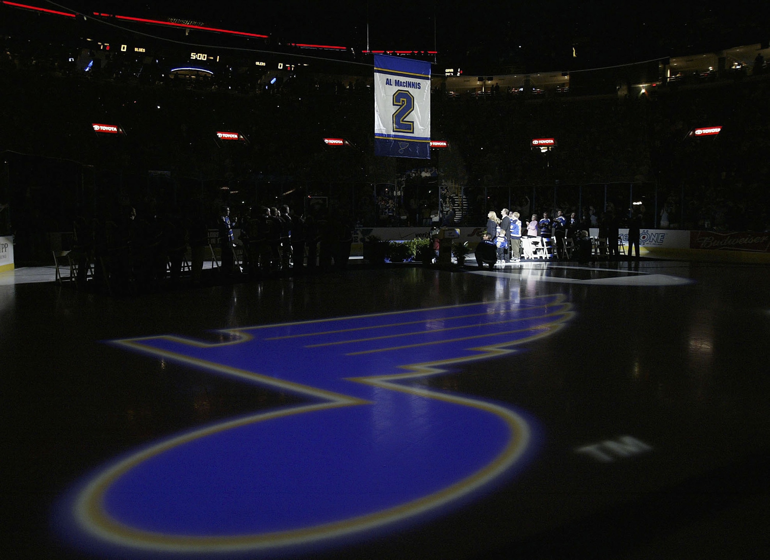 ST. LOUIS - APRIL 9:  Former St. Louis Blues defenseman Al MacInnis #2 and his family watch his banner being raised during his jersey retirement ceremony prior to the game between the Blues and Edmonton Oilers at the Savvis Center on April 9, 2006 in St.