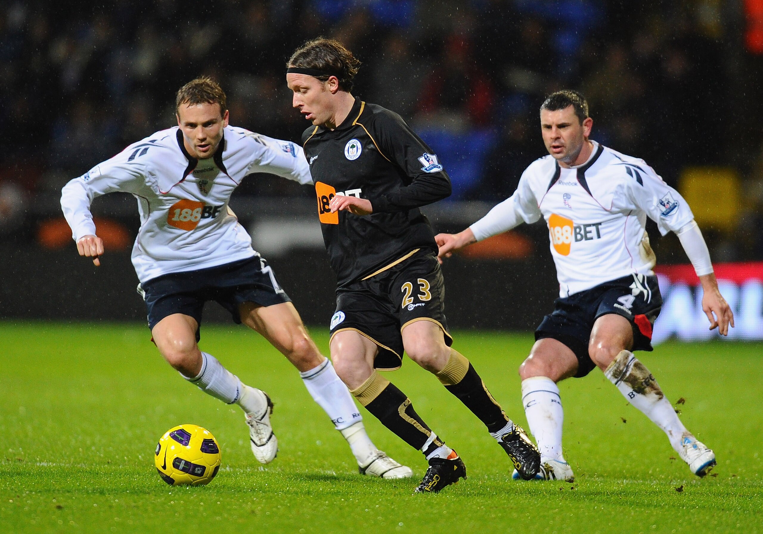 BOLTON, ENGLAND - JANUARY 05:  Ronnie Stam of Wigan Athletic is tackled by Matt Taylor of Bolton Wanderers during the Barclays Premier League match between Bolton Wanderers and Wigan Athletic at Reebok Stadium on January 5, 2011 in Bolton, England.  (Phot