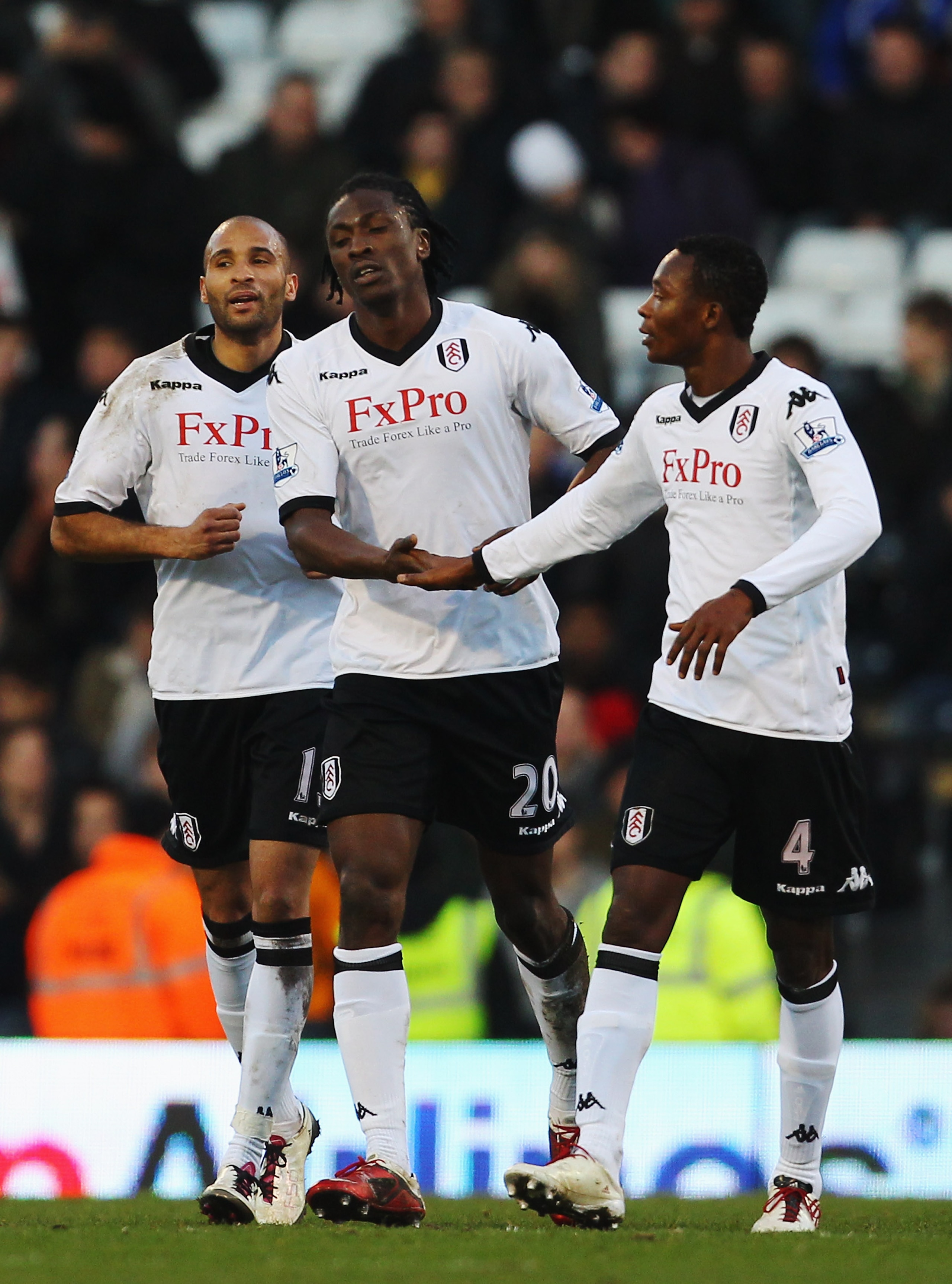 LONDON, UNITED KINGDOM - JANUARY 08:  Dickson Etuhu (C) of Fulham is congratulated by team mates Diomansy Kamara (L) and John Pantsil (R) after scoring his sides second goal during the FA Cup sponsored by E.ON 3rd Round match between between Fulham and Pe