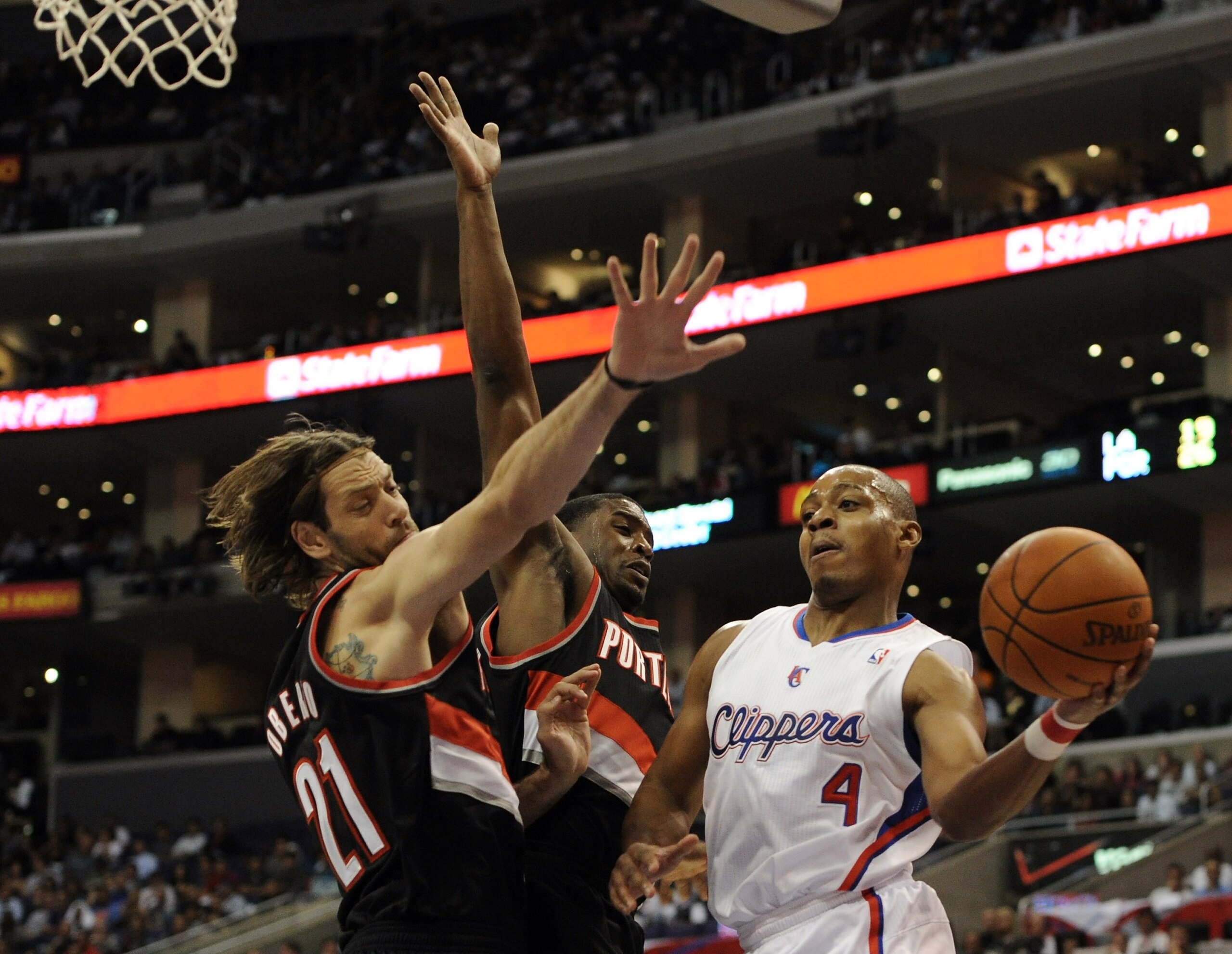 LOS ANGELES, CA - OCTOBER 27:  Randy Foye #4 of the Los Angeles Clippers attempts a layup around Fabricio Oberto #21 and Wesley Matthews #2 of the Portland Trail Blazers during the first half at Staples Center on October 27, 2010 in Los Angeles, Californi