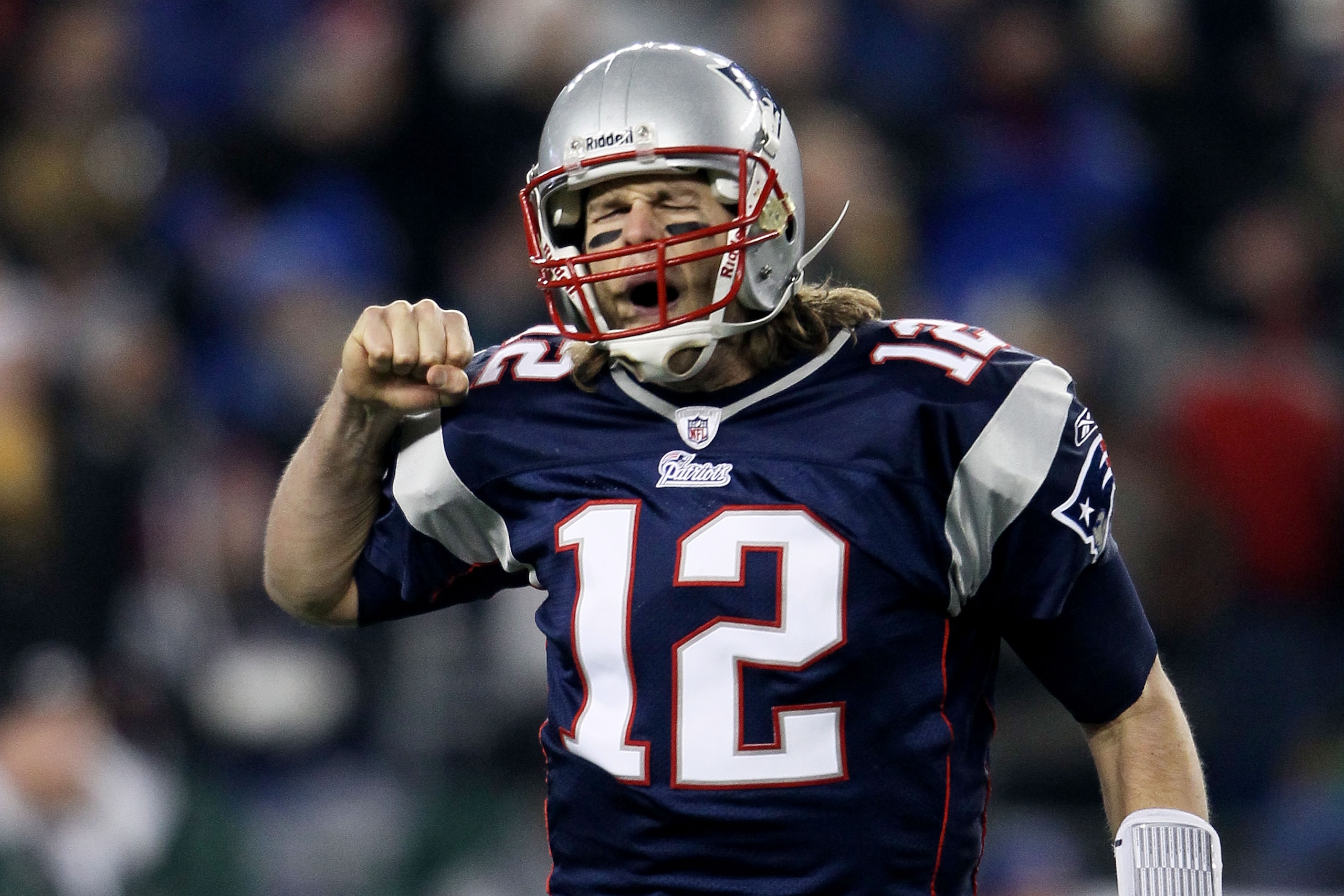 FOXBORO, MA - DECEMBER 19: Quarterback Tom Brady #12 of the New England Patriots celebrates a touchdown scored by running back BenJarvus Green-Ellis #42 (not pictured) against the Green Bay Packers in the first quarter of the game at Gillette Stadium on FOXBORO, MA - DECEMBER 19: Quarterback Tom Brady #12 of the New England Patriots celebrates a touchdown scored by running back BenJarvus Green-Ellis #42 (not pictured) against the Green Bay Packers in the first quarter of the game at Gillette Stadium on