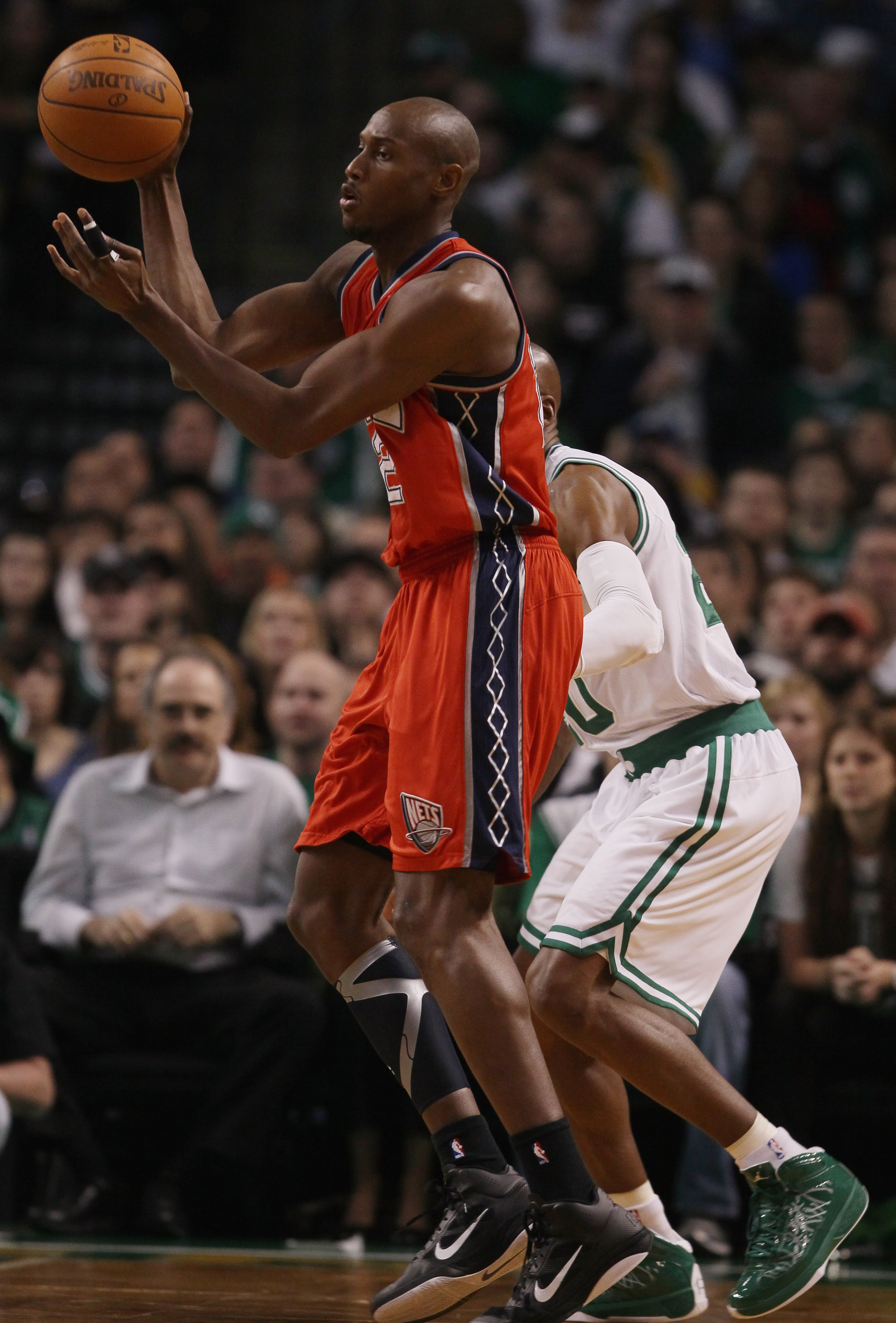 BOSTON - NOVEMBER 24:  Travis Outlaw #21 of the New Jersey Nets passes the ball as Ray Allen #20 of the Boston Celtics defends on November 24, 2010 at the TD Garden in Boston, Massachusetts. NOTE TO USER: User expressly acknowledges and agrees that, by do
