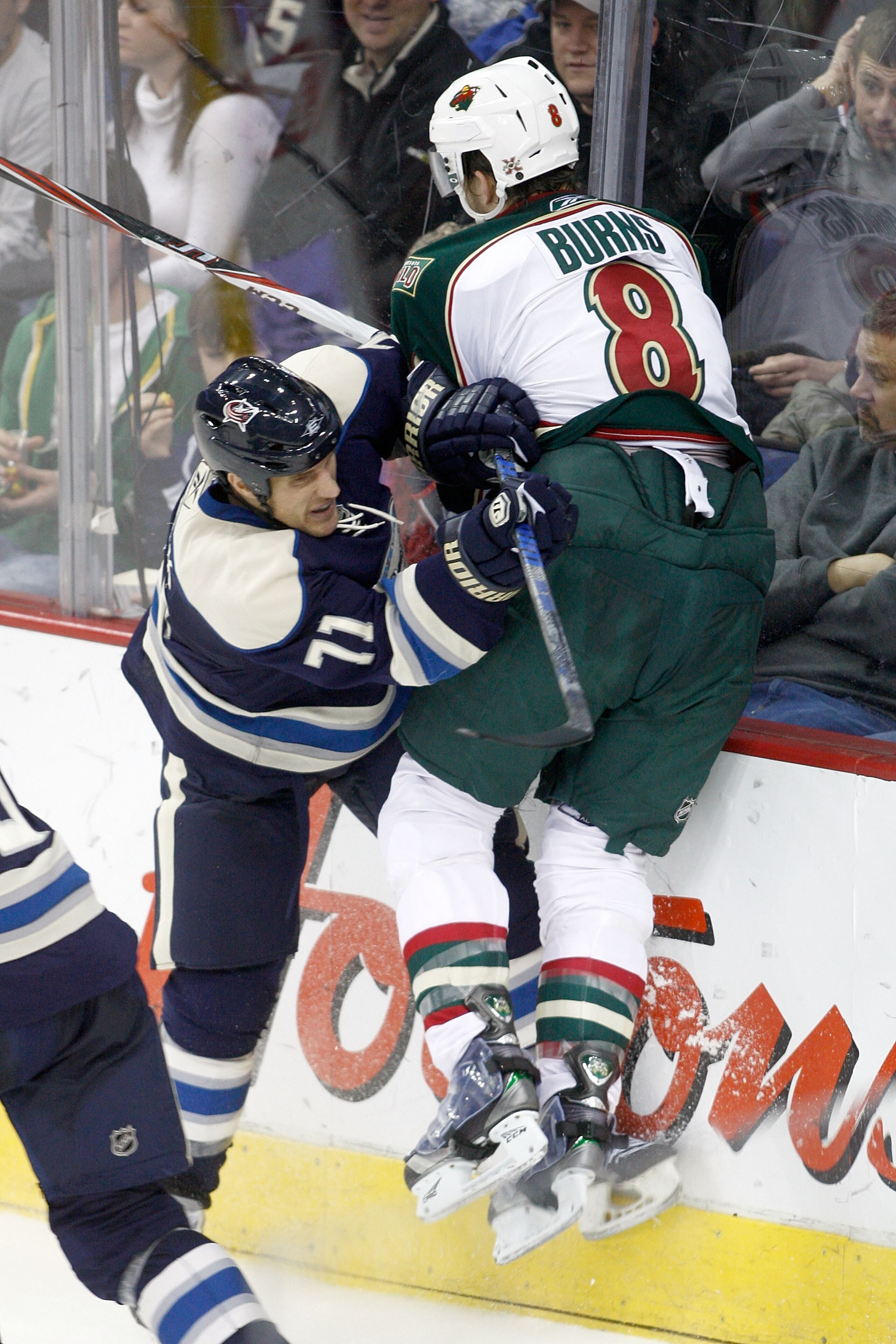 COLUMBUS, OH - DECEMBER 27:  Chris Clark #71 of the Columbus Blue Jackets checks Brent Burns #8 of the Minnesota Wild during the third period on December 27, 2010 at Nationwide Arena in Columbus, Ohio.  Columbus defeated Minnesota 4-3 in a shootout.  (Pho
