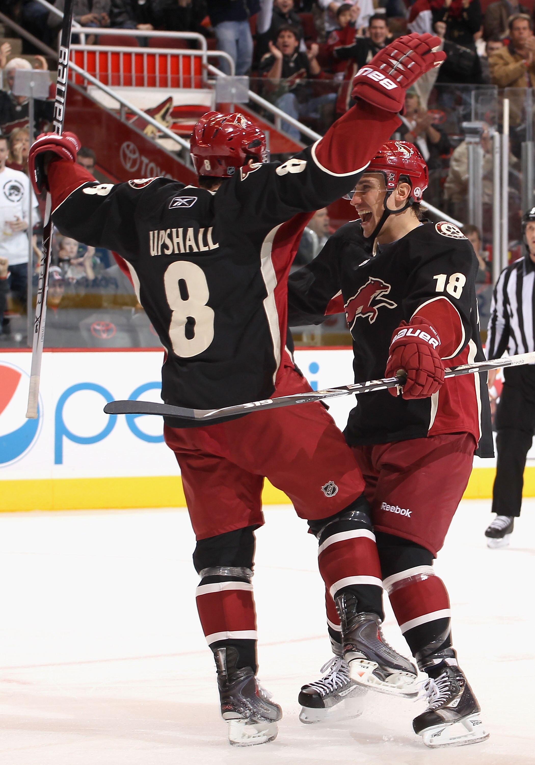 GLENDALE, AZ - JANUARY 04:  Scottie Upshall #8 of the Phoenix Coyotes celebrates with teammate Sami Lepisto #18 after Upshall scored a second period goal against the Columbus Blue Jackets during the NHL game at Jobing.com Arena on January 4, 2011 in Glend