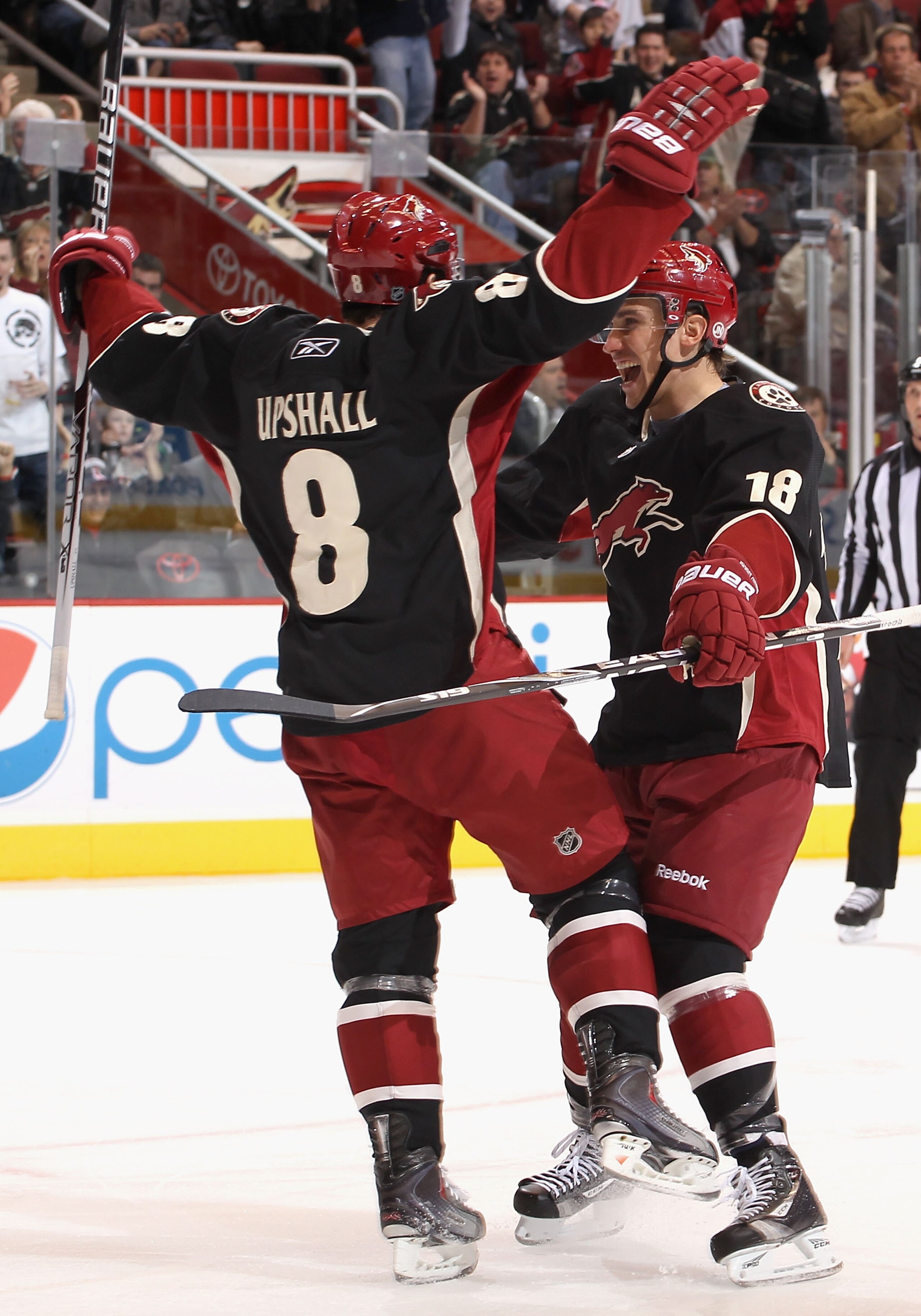 GLENDALE, AZ - JANUARY 04:  Scottie Upshall #8 of the Phoenix Coyotes celebrates with teammate Sami Lepisto #18 after Upshall scored a second period goal against the Columbus Blue Jackets during the NHL game at Jobing.com Arena on January 4, 2011 in Glend