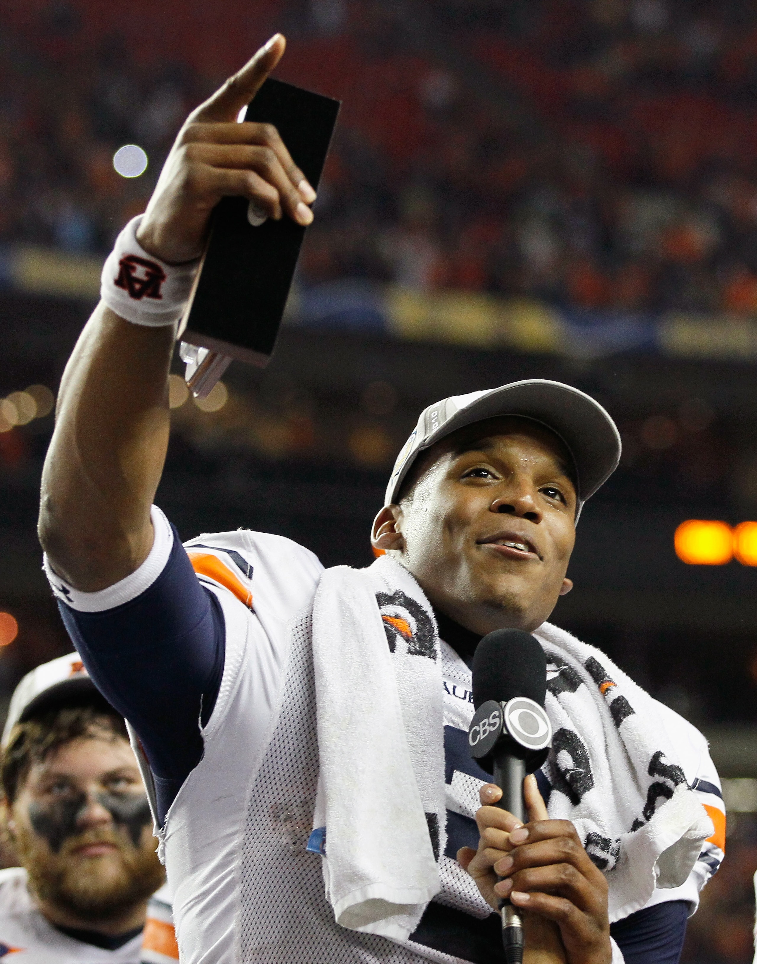 ATLANTA, GA - DECEMBER 04:  Quarterback Cam Newton #2 of the Auburn Tigers celebrates after winning the MVP trophy in their 56-17 win over the South Carolina Gamecocks during the 2010 SEC Championship at Georgia Dome on December 4, 2010 in Atlanta, Georgi