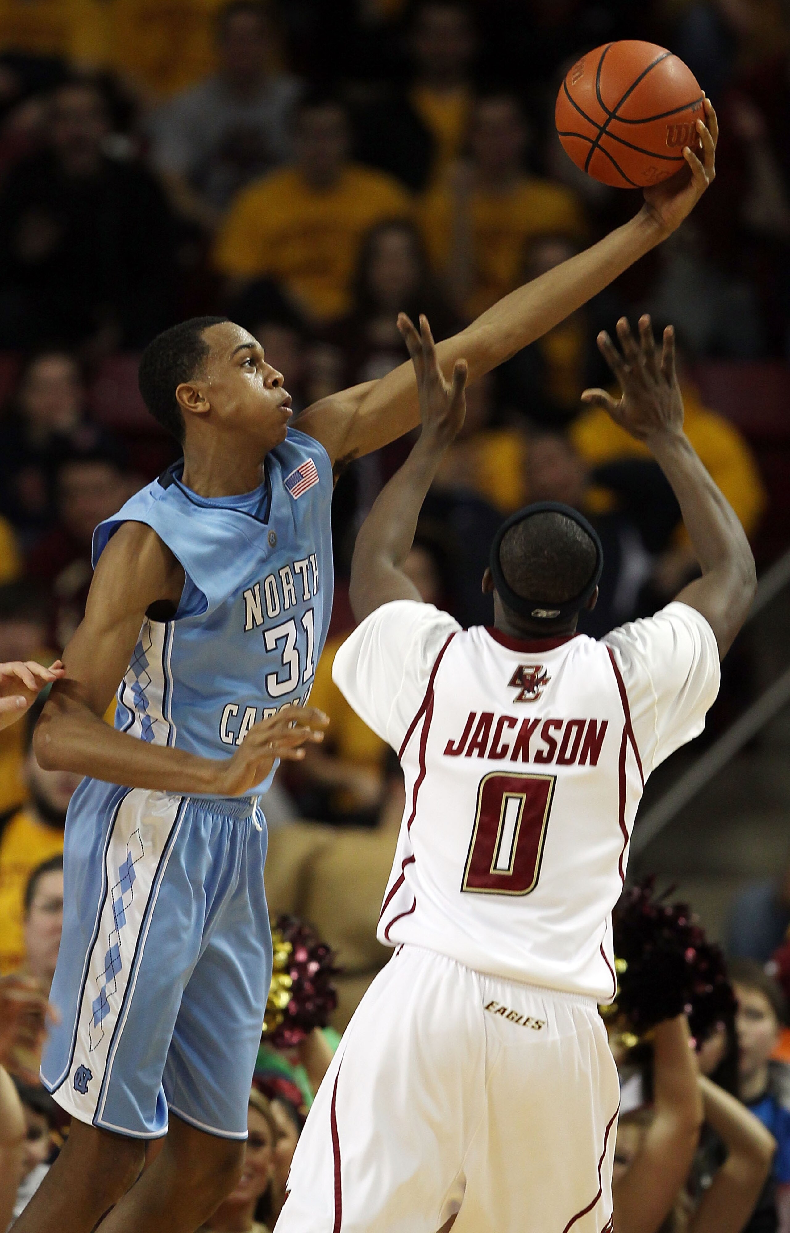 CHESTNUT HILL, MA - FEBRUARY 20:  John Henson #11 of the North Carolina Tar Heels grabs the ball as Reggie Jackson #0 of the Boston College Eagles defends on February 20, 2010 at Conte Forum in Chestnut Hill, Massachusetts.  (Photo by Elsa/Getty Images)