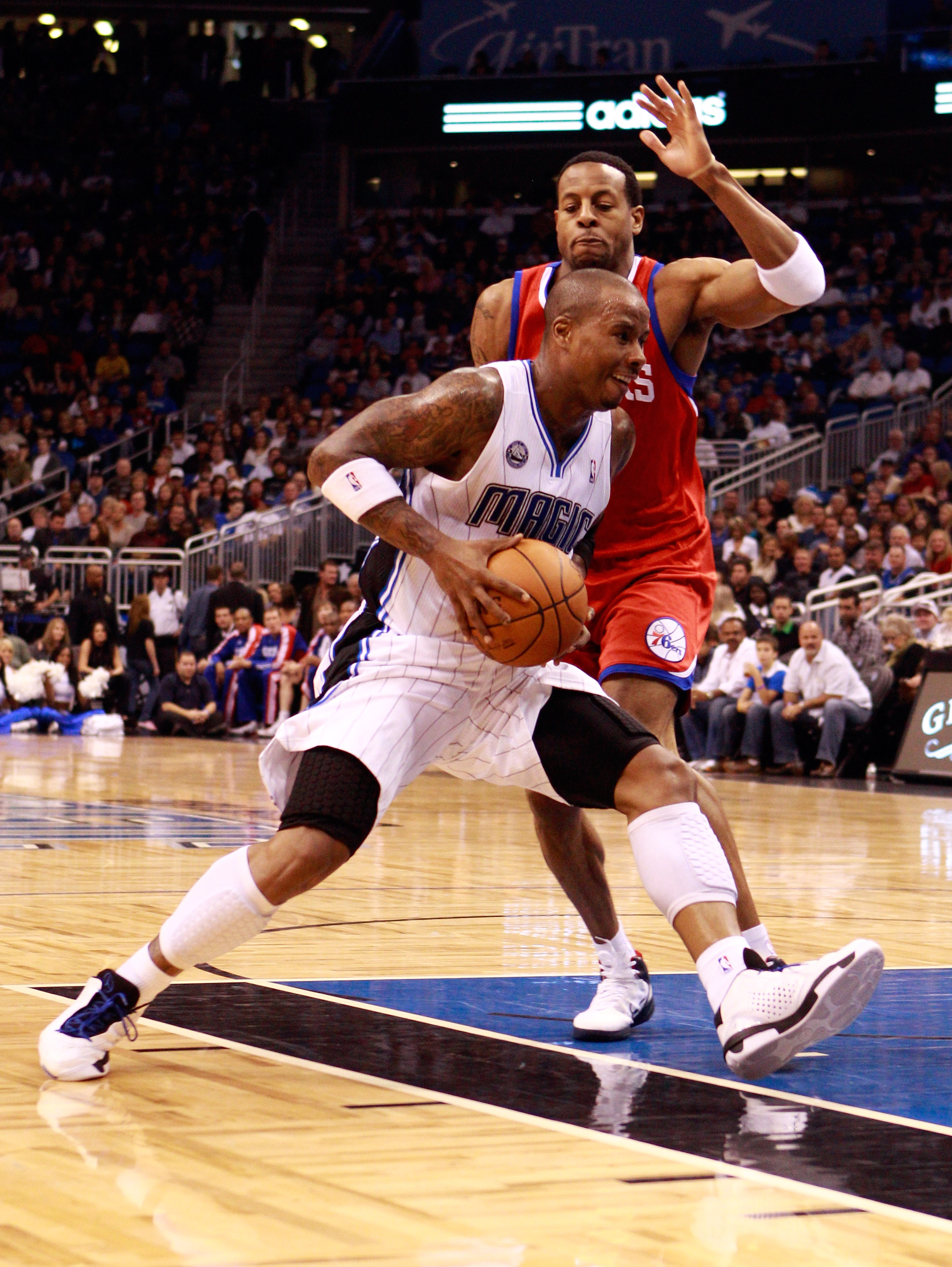 ORLANDO, FL - DECEMBER 18:  Quentin Richardson #5 of the Orlando Magic drives against Andre Iguodala #9 of the Philadelphia 76ers during the game at Amway Arena on December 18, 2010 in Orlando, Florida.  NOTE TO USER: User expressly acknowledges and agree
