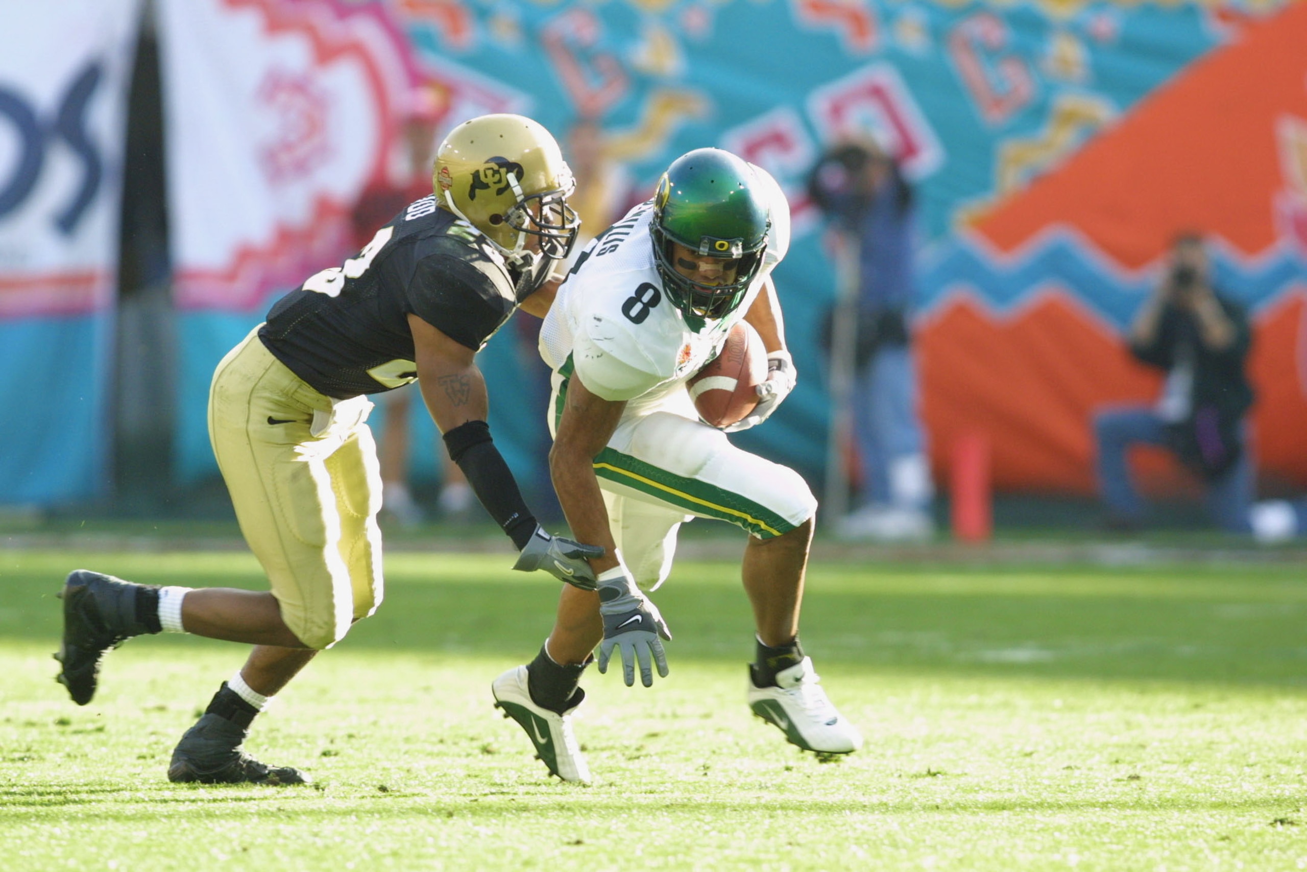 01 Jan 2002 : Jason Willis #8 of Oregon is pressured by Terrence Wood #23 of Colorado during the game at the Fiesta Bowl at Sun Devil Stadium in Tempe, Arizona. The Oregon Ducks won 38-16. DIGITAL IMAGE. Mandatory Credit: Jeff Gross/Getty Images 01 Jan 2002 : Jason Willis #8 of Oregon is pressured by Terrence Wood #23 of Colorado during the game at the Fiesta Bowl at Sun Devil Stadium in Tempe, Arizona. The Oregon Ducks won 38-16. DIGITAL IMAGE. Mandatory Credit: Jeff Gross/Getty Images
