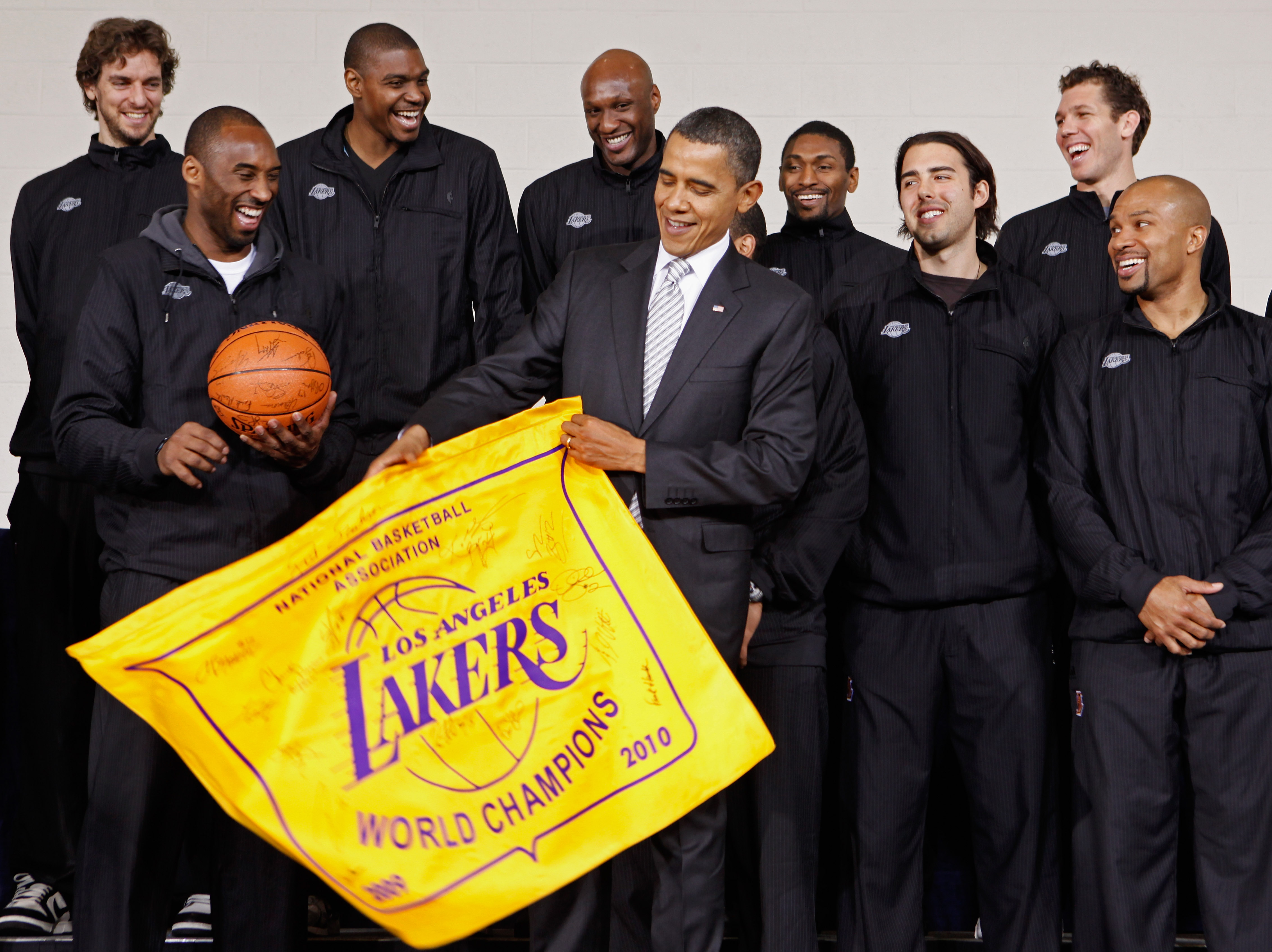 WASHINGTON, DC - DECEMBER 13:  (AFP OUT) U.S. President Barack Obama (C) receives an autographed championship flag and basketball from members of the Los Angeles Lakers (L-R) Paul Gasol, Kobe Bryant, Andrew Bynum, Lamar Odom, Ron Artest, Aleksandar Vujaci
