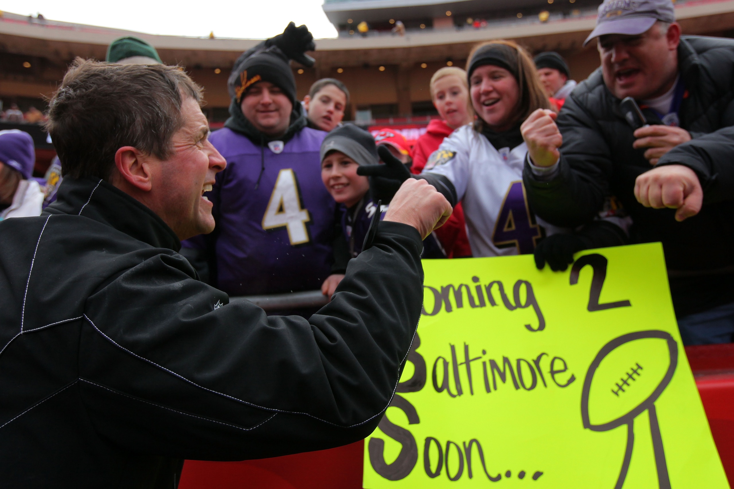 KANSAS CITY, MO - JANUARY 09: Head coach John Harbaugh of the Baltimore Ravens celebrates with fans in the stands after defeating the Kansas City Chiefs 30-7 in the 2011 AFC wild card playoff game at Arrowhead Stadium on January 9, 2011 in Kansas City, M KANSAS CITY, MO - JANUARY 09: Head coach John Harbaugh of the Baltimore Ravens celebrates with fans in the stands after defeating the Kansas City Chiefs 30-7 in the 2011 AFC wild card playoff game at Arrowhead Stadium on January 9, 2011 in Kansas City, M