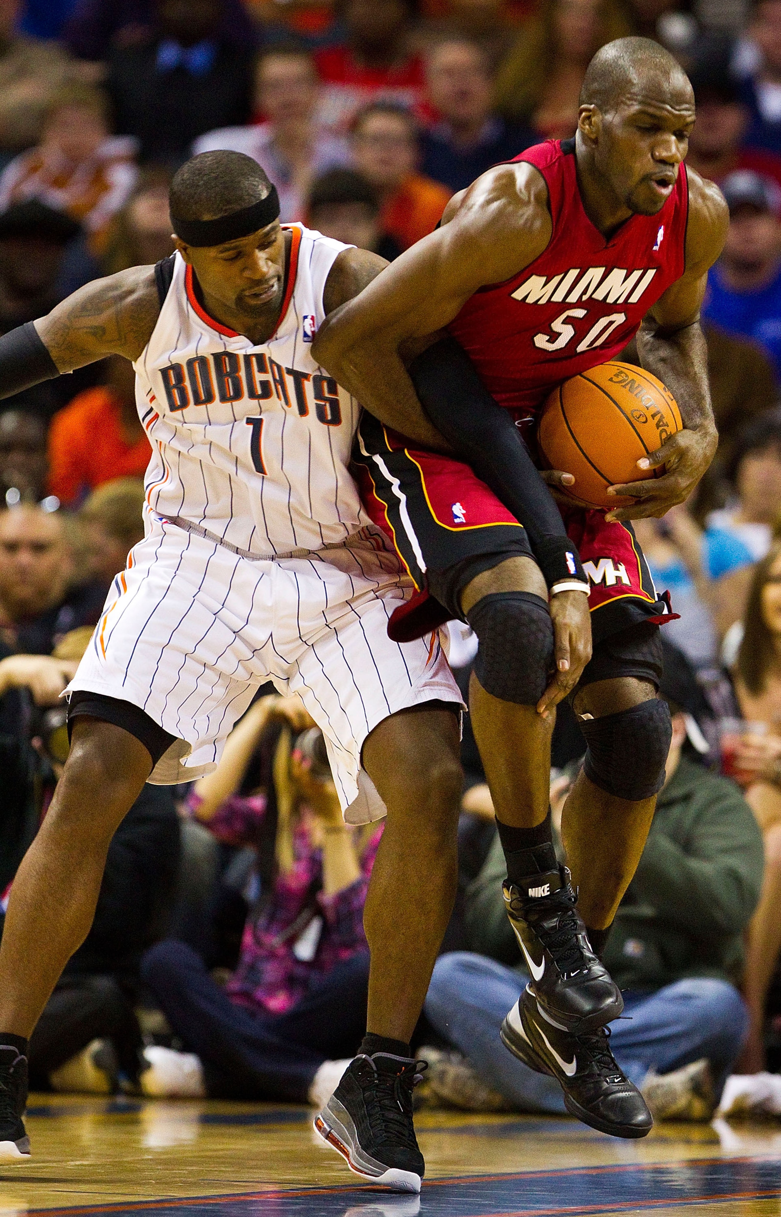 CHARLOTTE, NC - JANUARY 03: Stephen Jackson #1 of the Charlotte Bobcats battles for the ball with Joel Anthony #50 of the Miami Heat at Time Warner Cable Arena on January 3, 2011 in Charlotte, North Carolina.  The Heat defeated the Bobcats 96-82.  (Photo