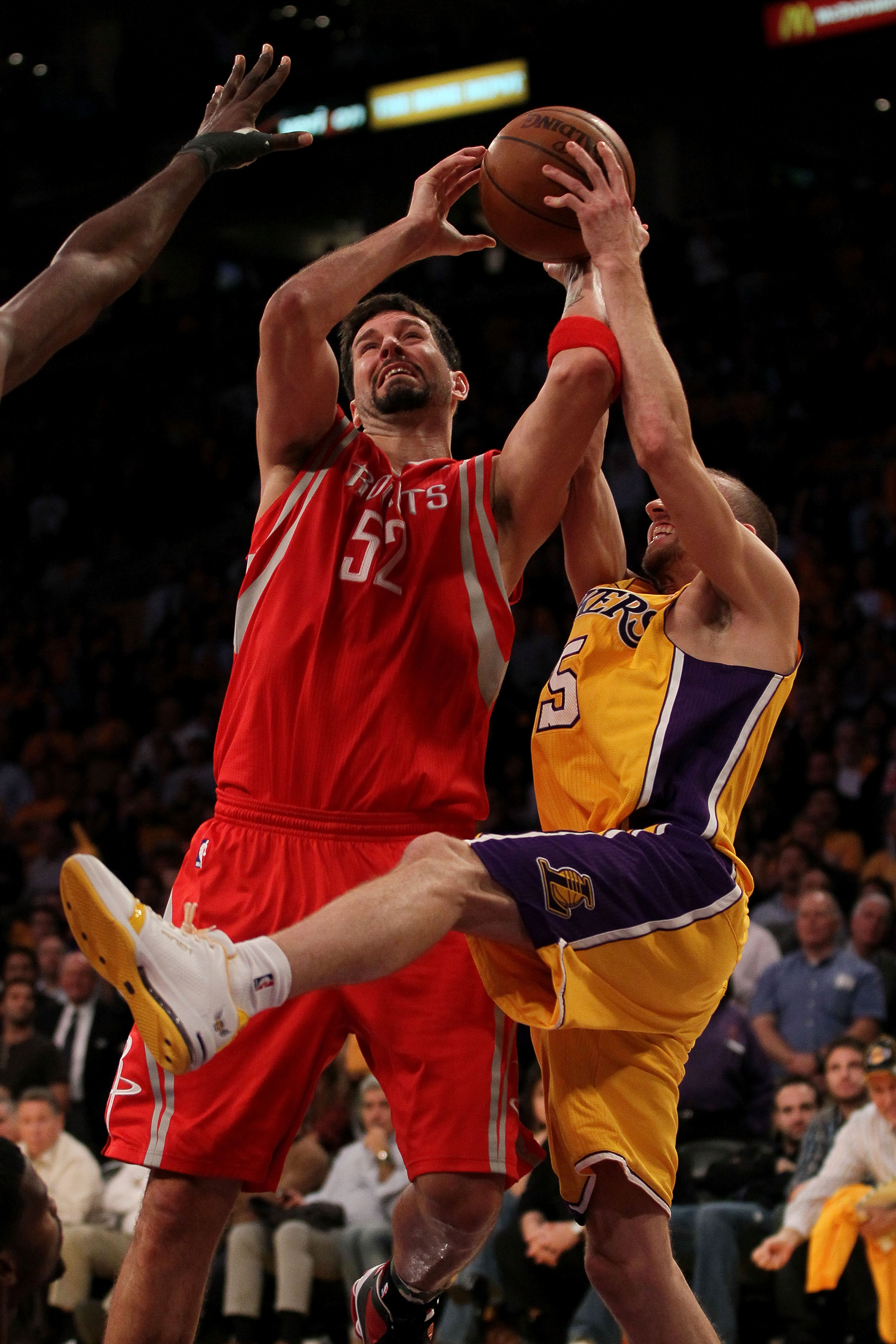 LOS ANGELES, CA - OCTOBER 26:  Steve Blake #5 of the Los Angeles Lakers fights for a rebound with Brad Miller #52 of the Houston Rockets during their opening night game at Staples Center on October 26, 2010 in Los Angeles, California. NOTE TO USER: User e