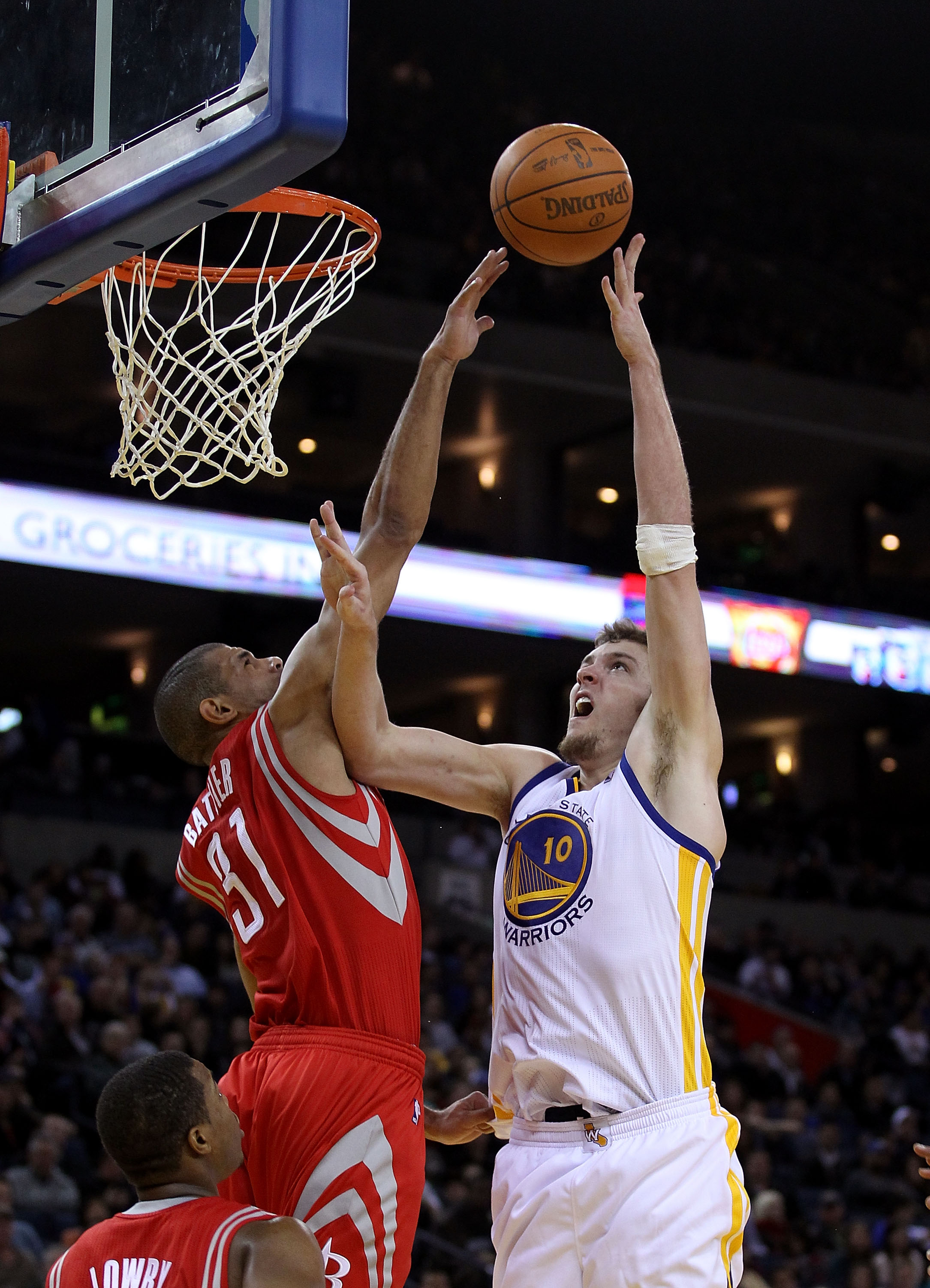 OAKLAND, CA - DECEMBER 20:  David Lee #10 of the Golden State Warriors shoots over Shane Battier #31 of the Houston Rockets at Oracle Arena on December 20, 2010 in Oakland, California. NOTE TO USER: User expressly acknowledges and agrees that, by download